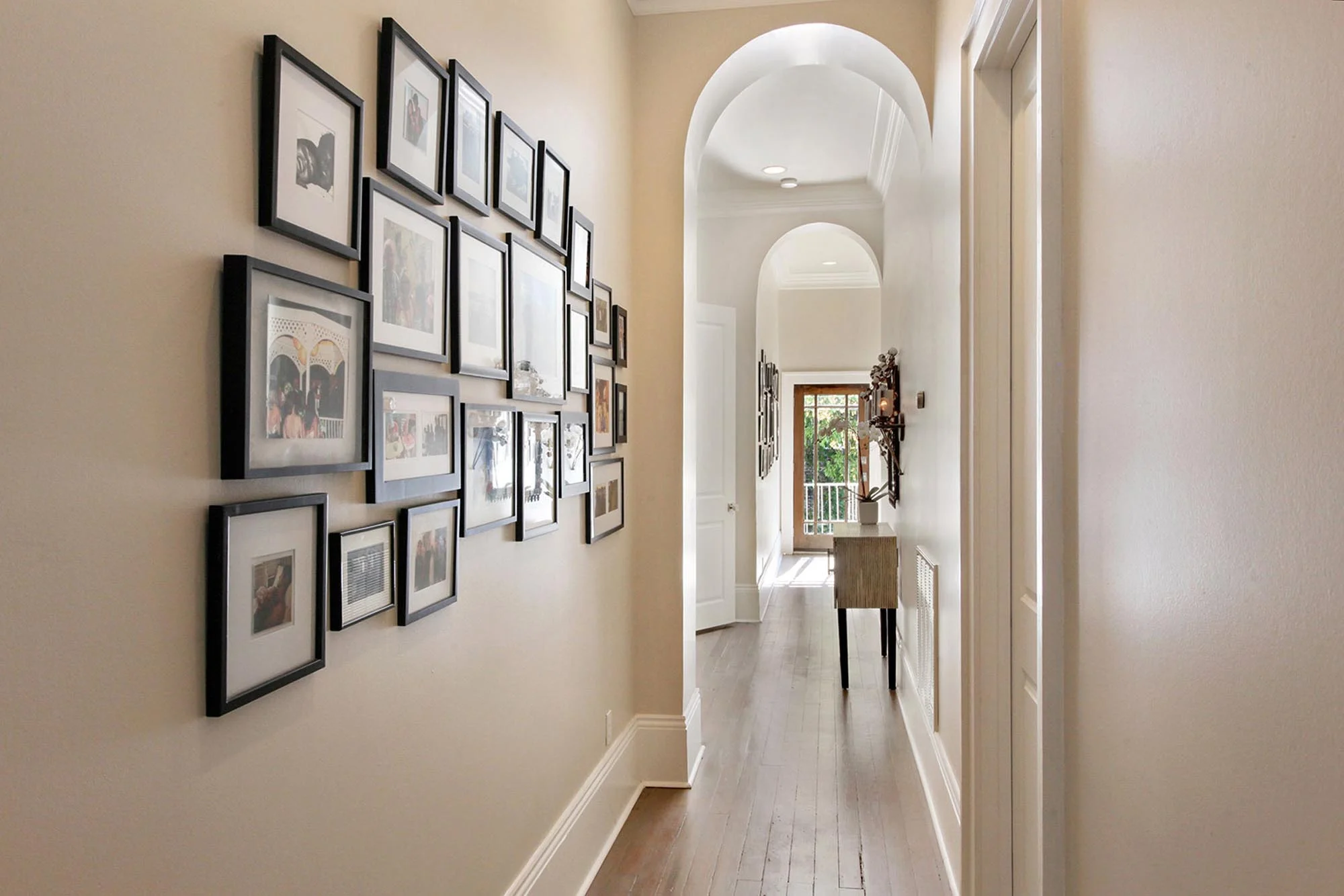 Hallway with frames hanging on wall