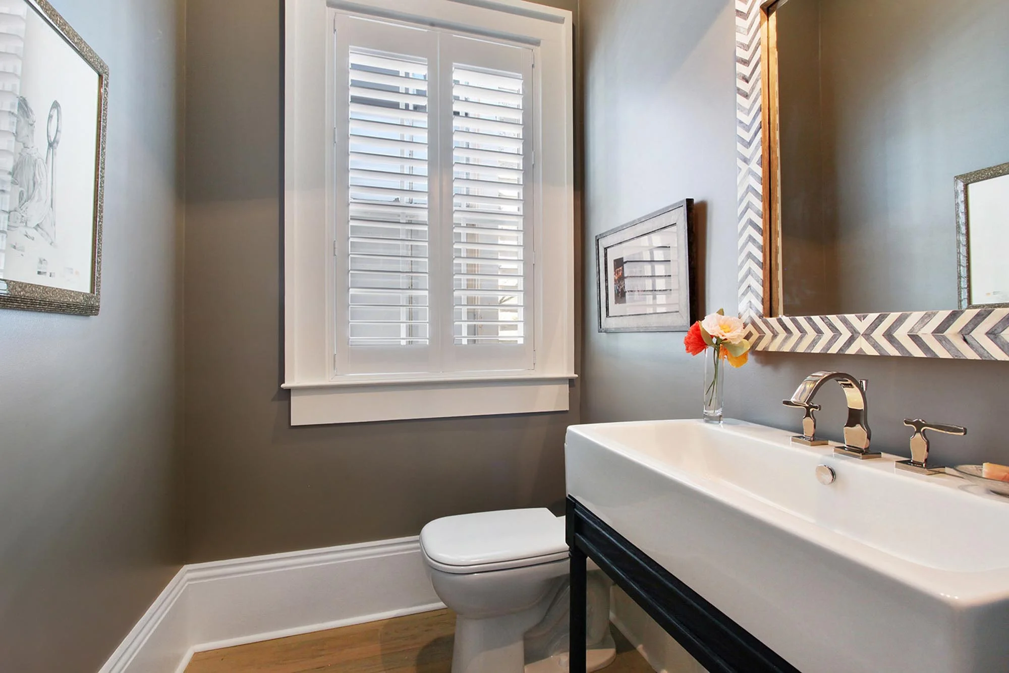Stylish bathroom with decorative framed mirror over a long sink