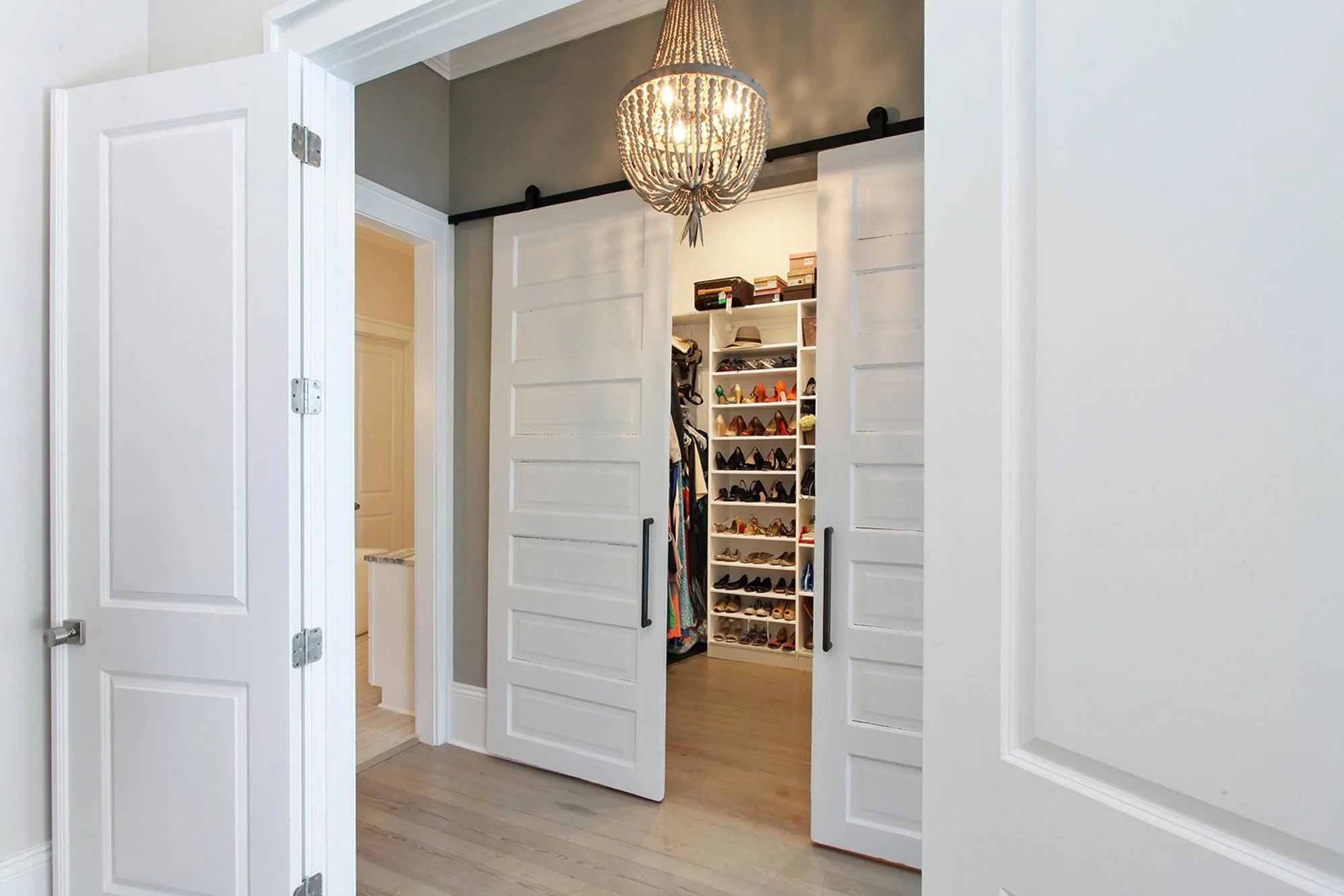 Walk in closet with wood empire chandelier