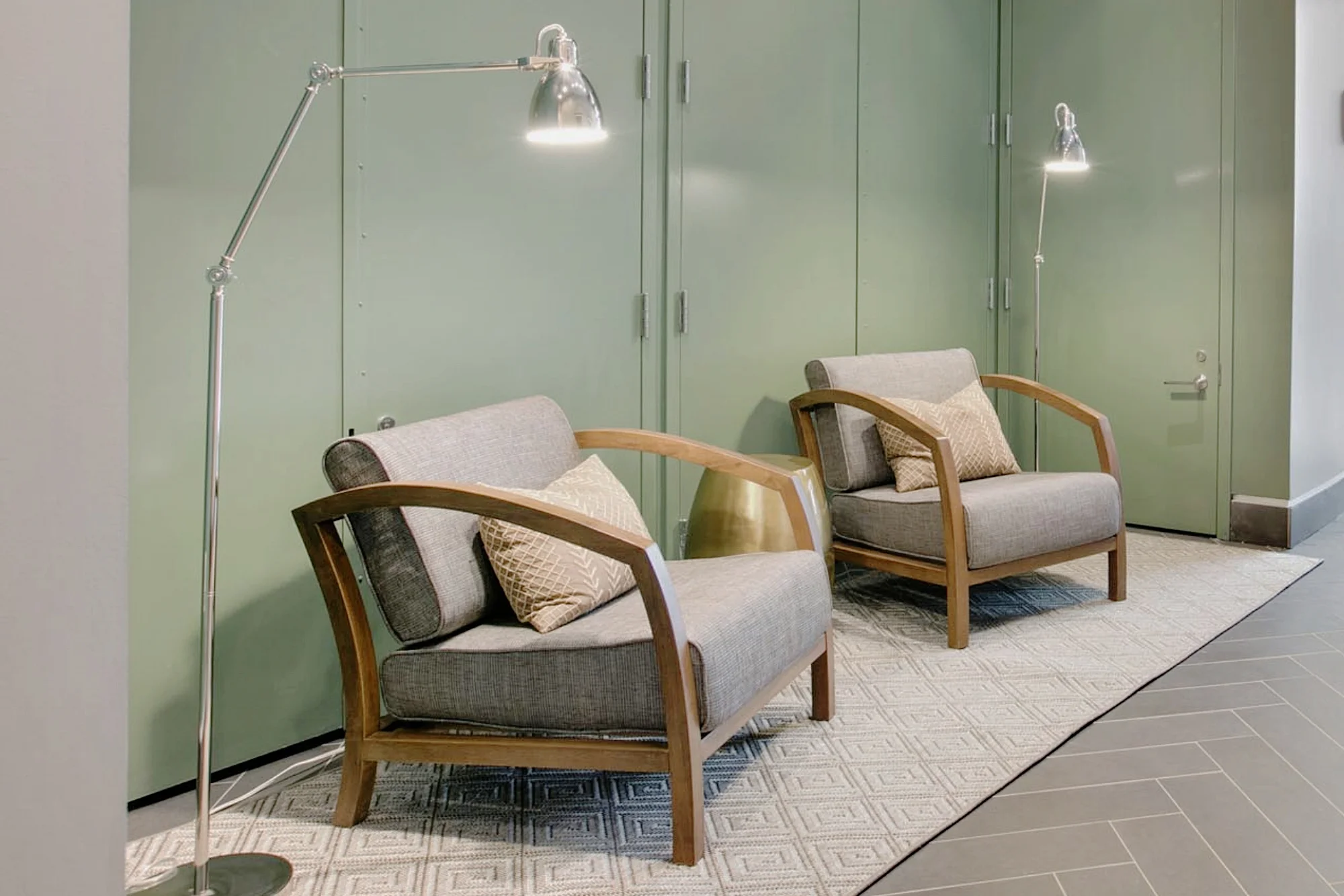 Hallway space with green walls and soft chairs