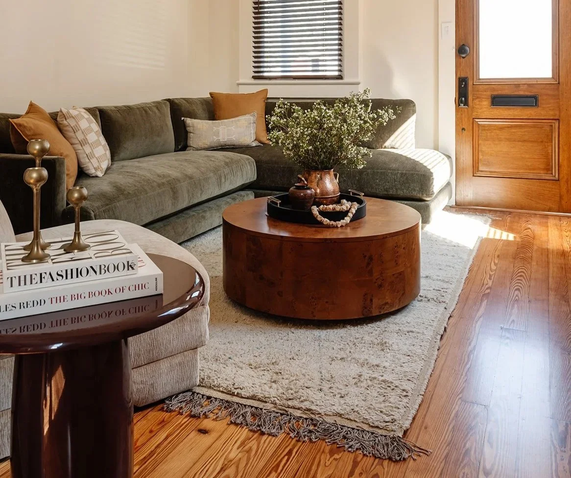 living room with green sofa and brown coffee table