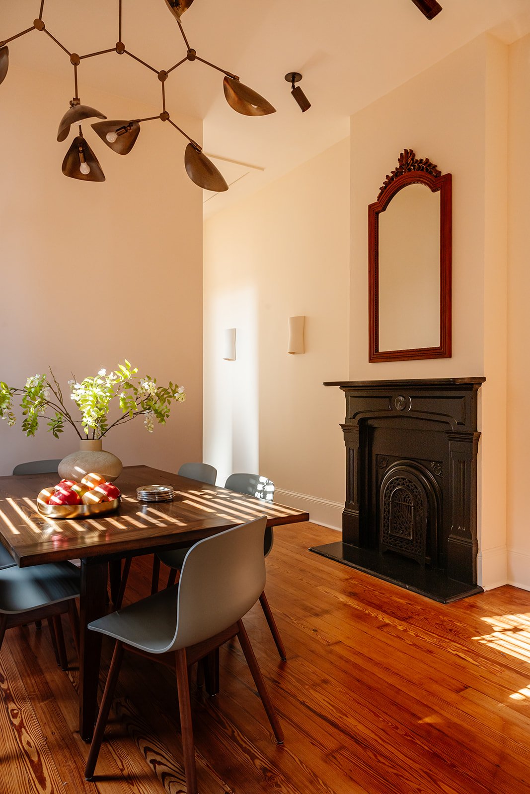Dining room: Dining room with original fireplace, antique mirror and barge board dining table in a New Orleans renovation