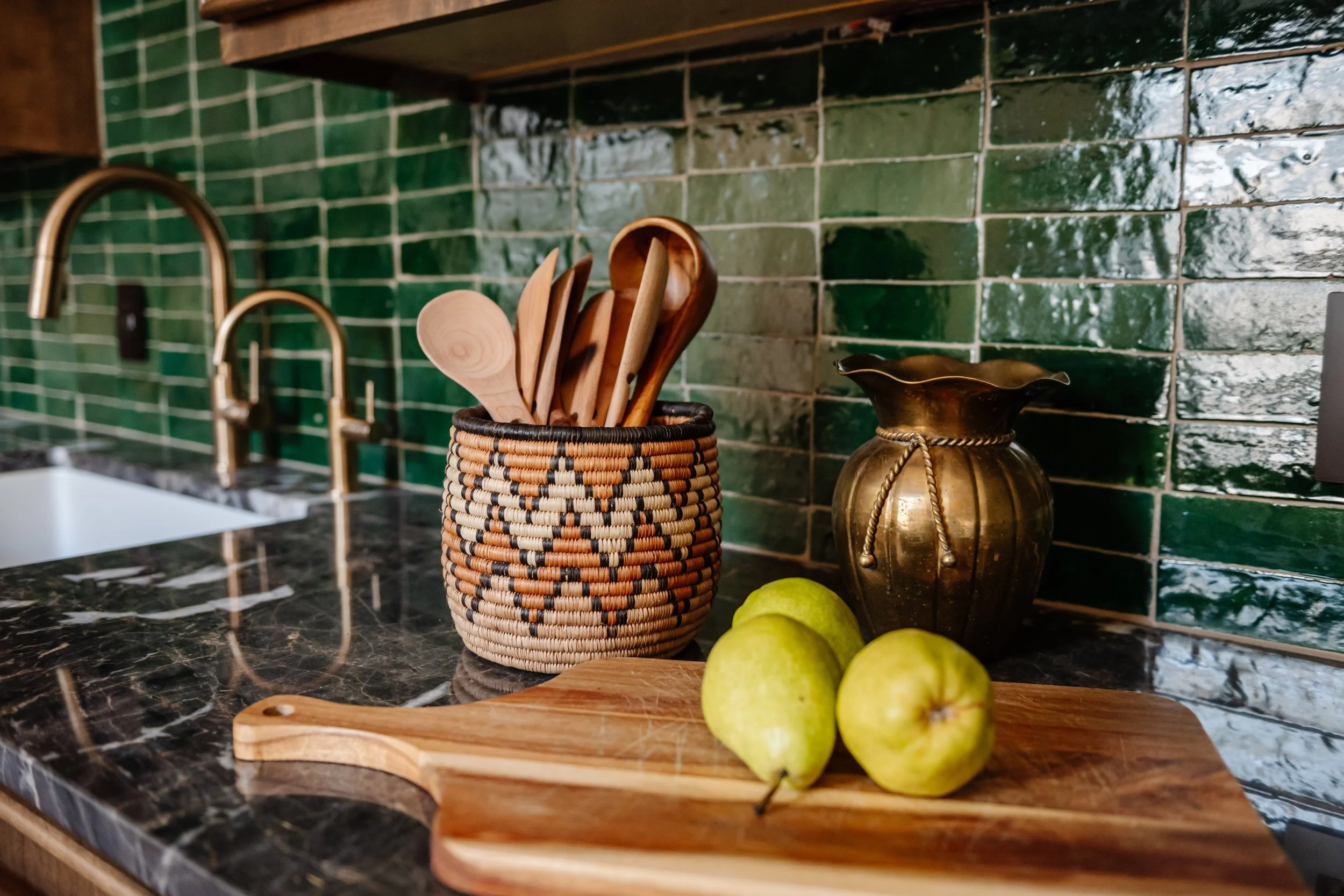 Tile detail: Green zellige tile and brass faucet detail in a custom New Orleans kitchen