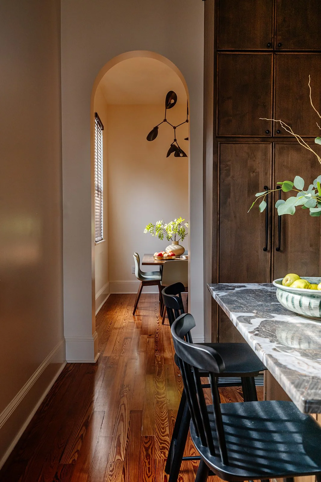 Arched hallway: Arched hallway with custom wood cabinetry in a renovated Riverbend shotgun home