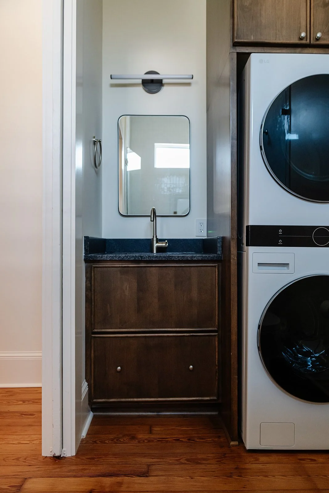 Laundry bath: Hall bathroom with custom vanity and stacked laundry in a shotgun renovation