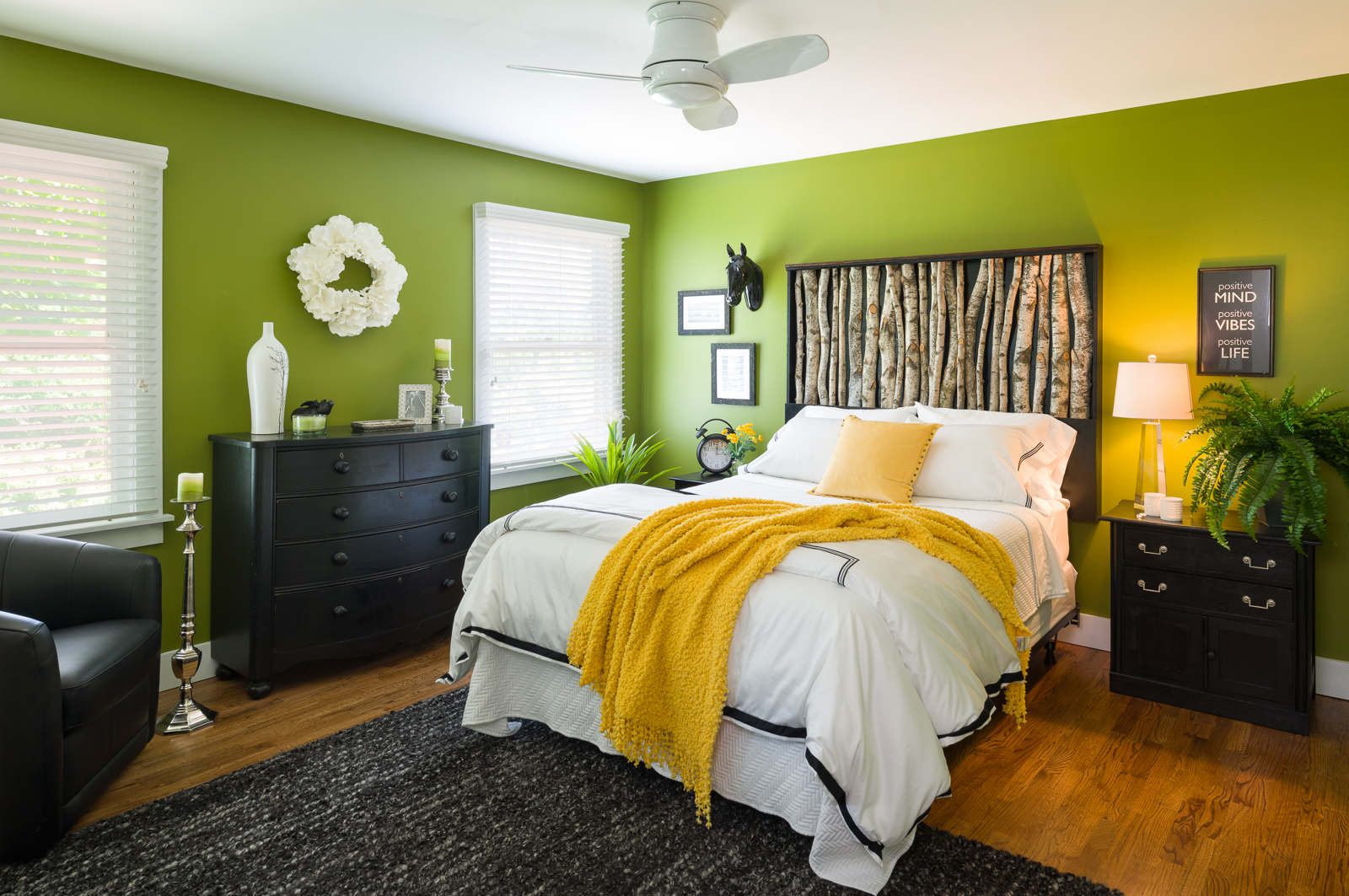 After - Oh yes! This is the same bedroom. New paint and trim, a different fan, a custom bed, bedding, furnishings and accessories welcome guests to this country home. 