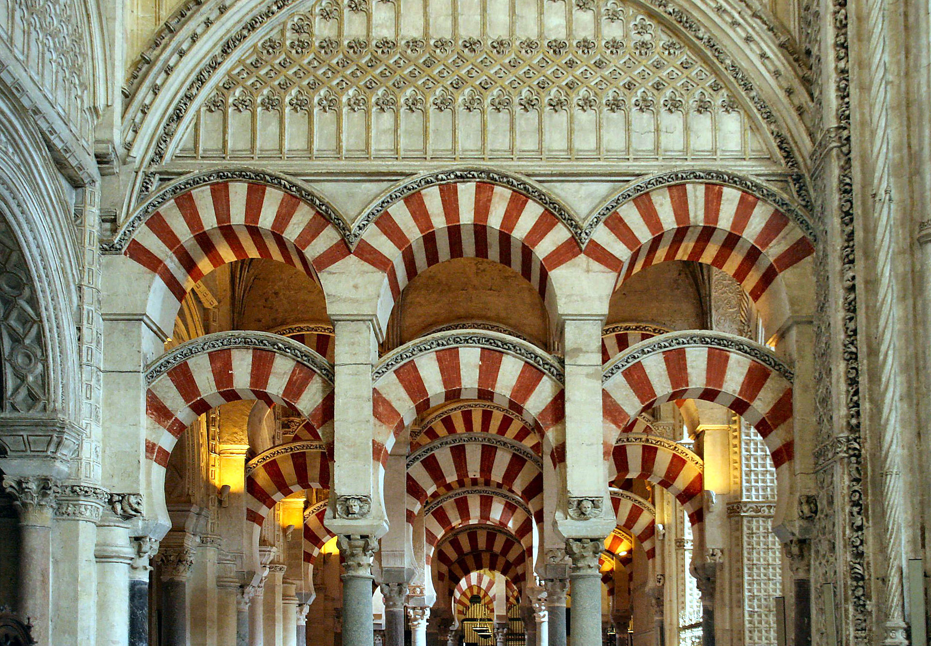 Texture, color, pattern and lighting are key elements in the design of the Mosque of Cordoba. The stripes were made using two different materials and the overlapping arches create new geometric forms. - Image from Wikipedia .
