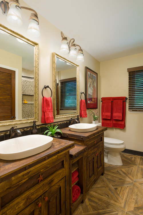 A true example of practical also looking amazing. Those parquet "wood" floors in our client's guest bathroom are actually porcelain tile. Design by Ella Design Group . Photo by Paul S. Bartholomew .