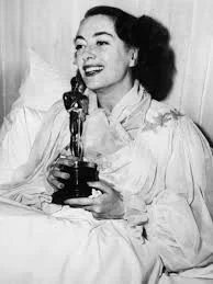 Carrying her Best Actress Oscar for Mildred Pierce (1945)