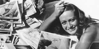 Signing photographs for her fans