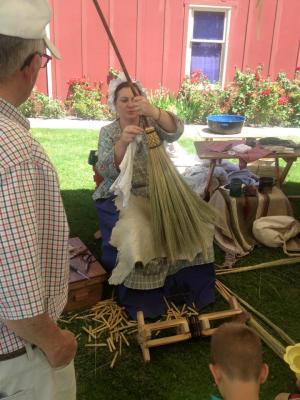 Photo of one of last year's vendors creating hand made brooms while at the festival. 