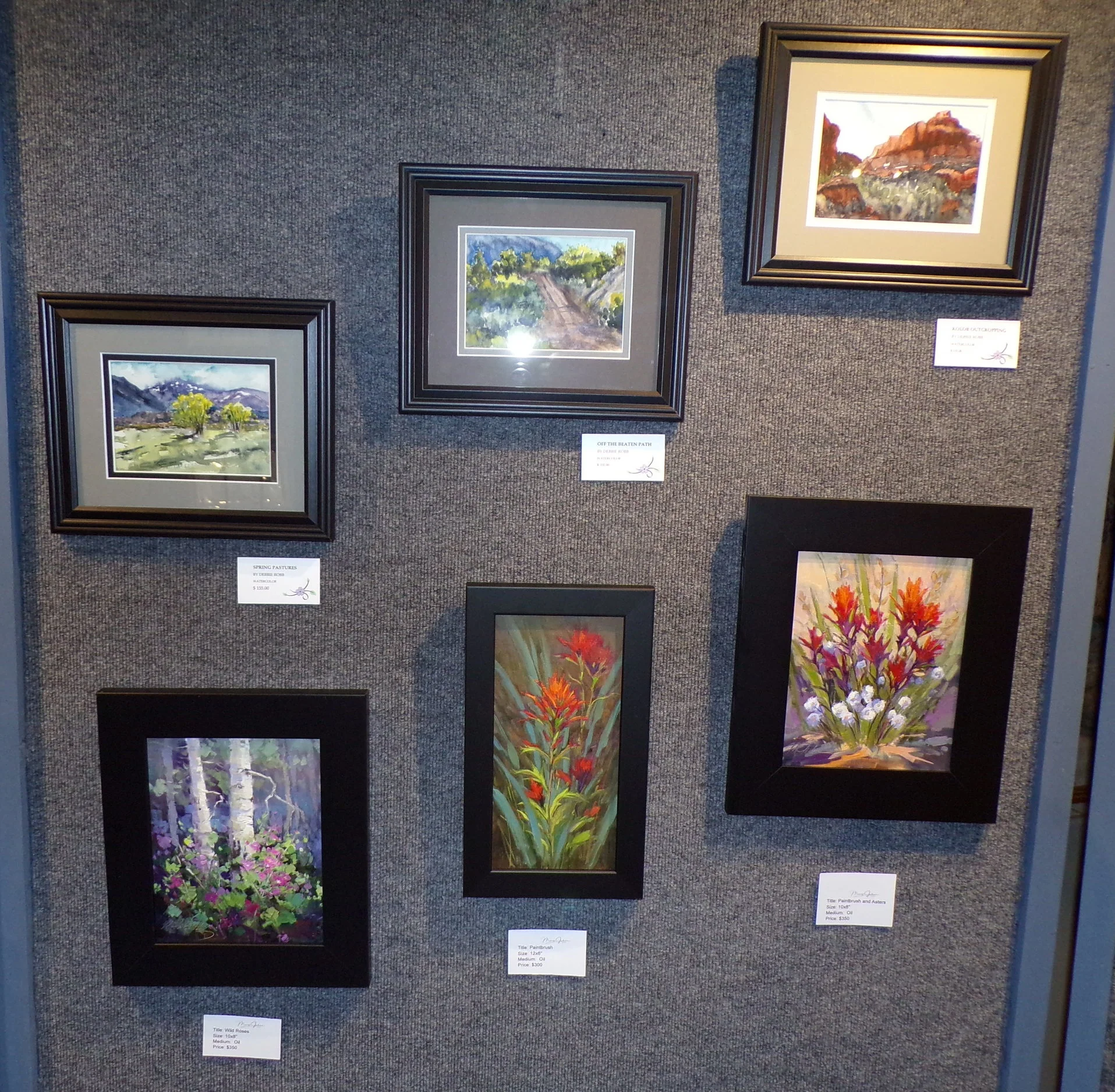 Three watercolors by Debbie Robb and three oil paintings by Mary Jabens.