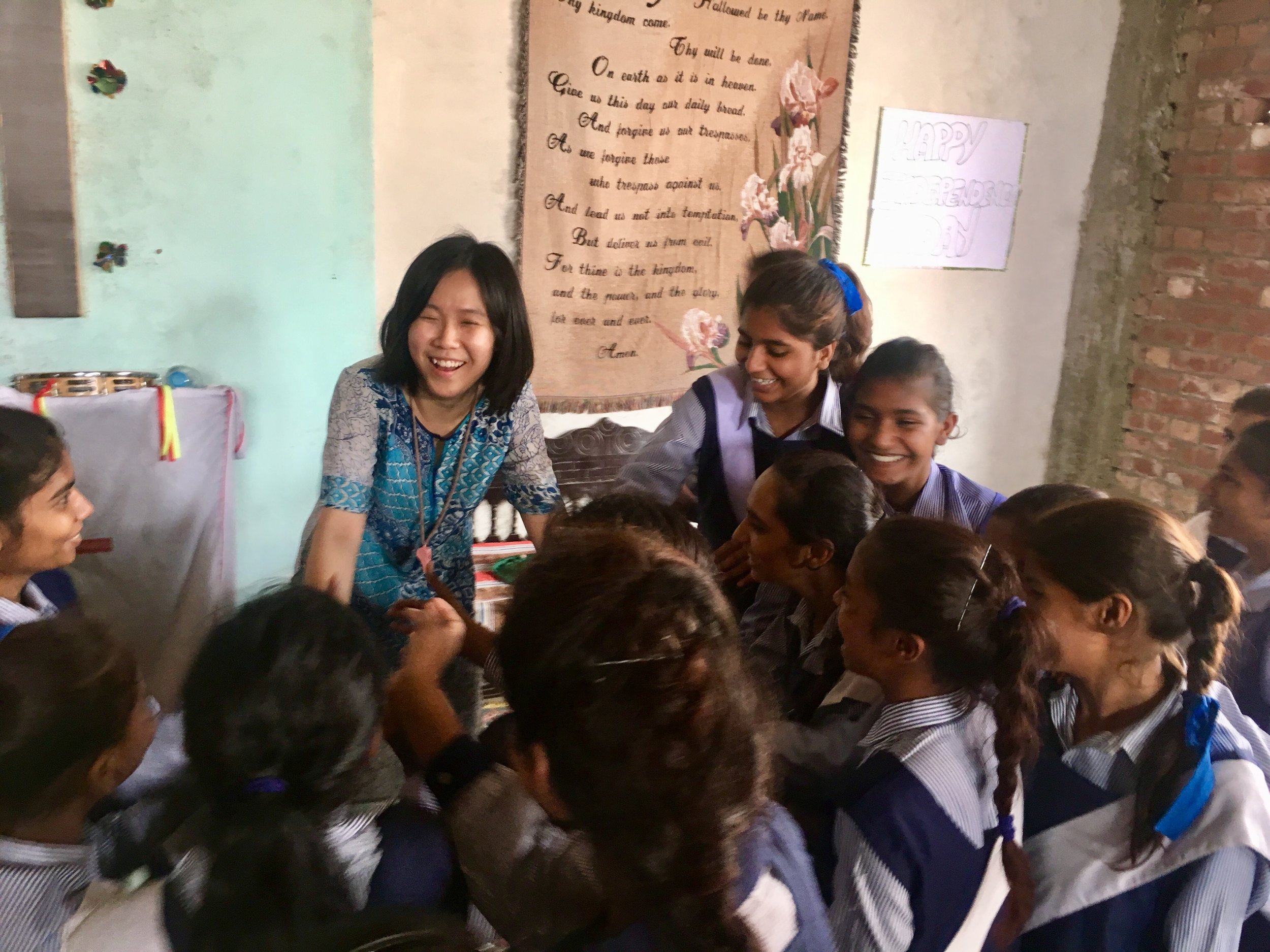 Above: Lee Wai Teng (BMus '16, Clarinet) with impoverished students in Pakistan 