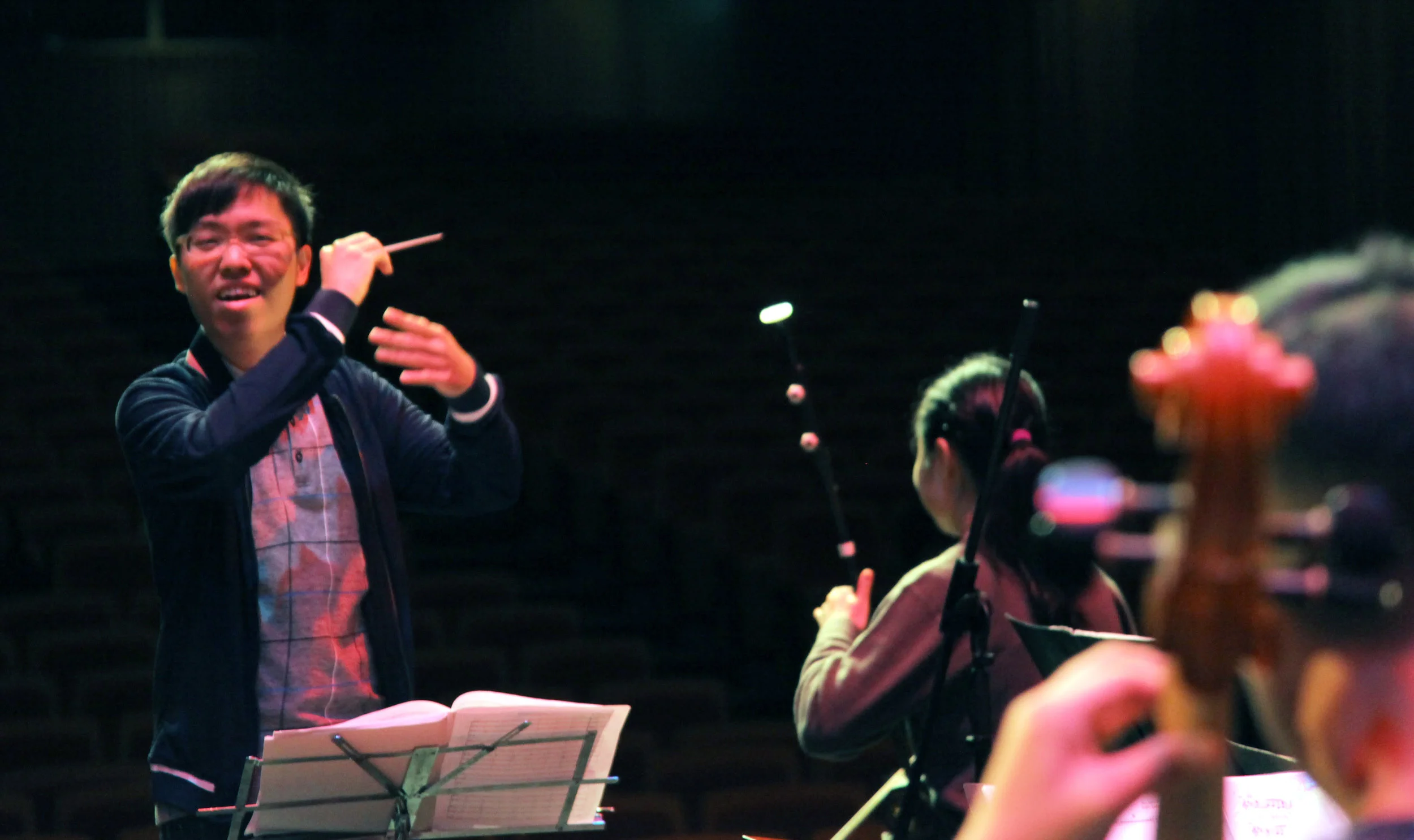 Above: Sulwyn Lok (left) leads his orchestra through a rehearsal.