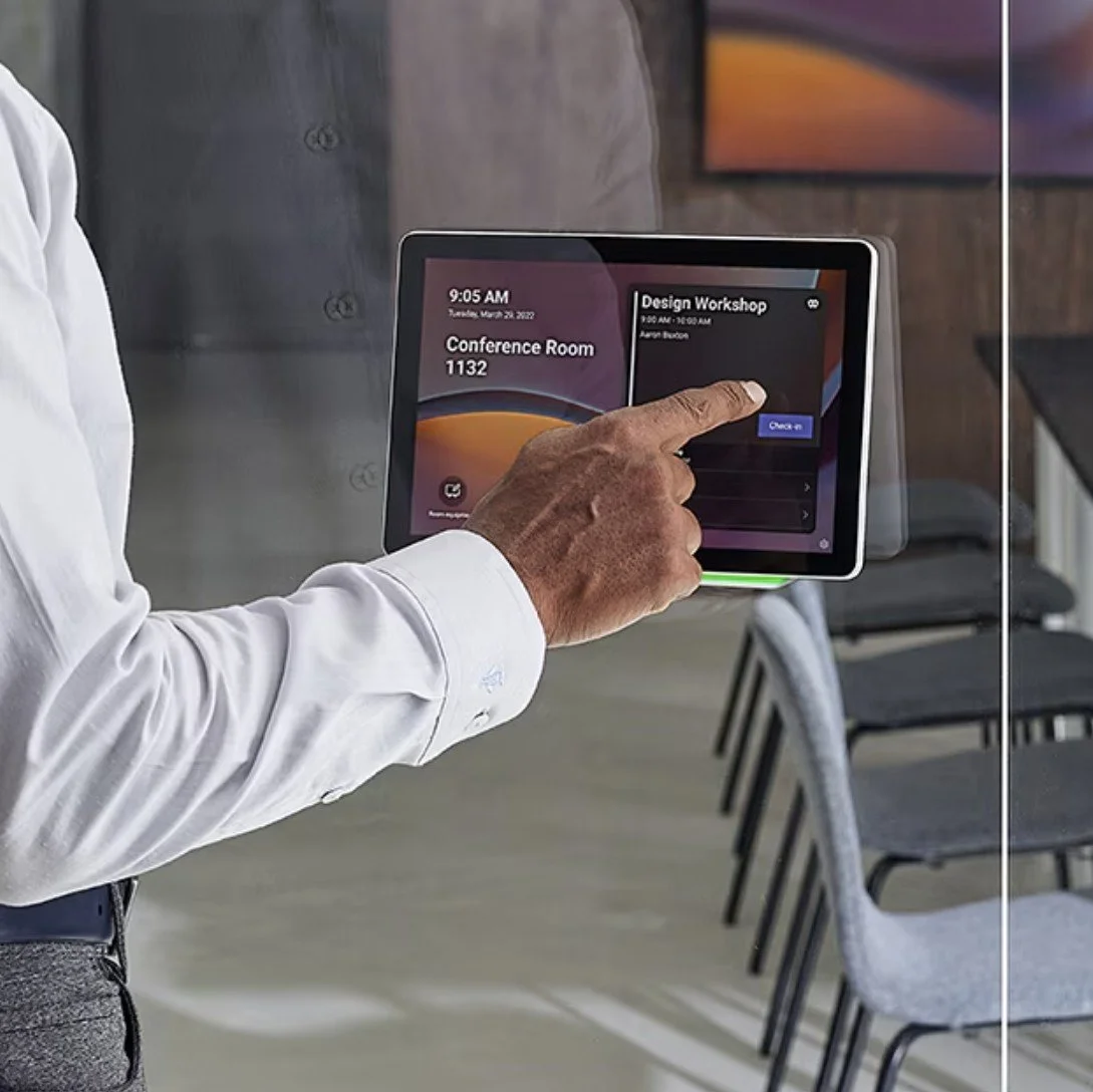 Man interacting with a Microsoft Teams Room Booking Panel