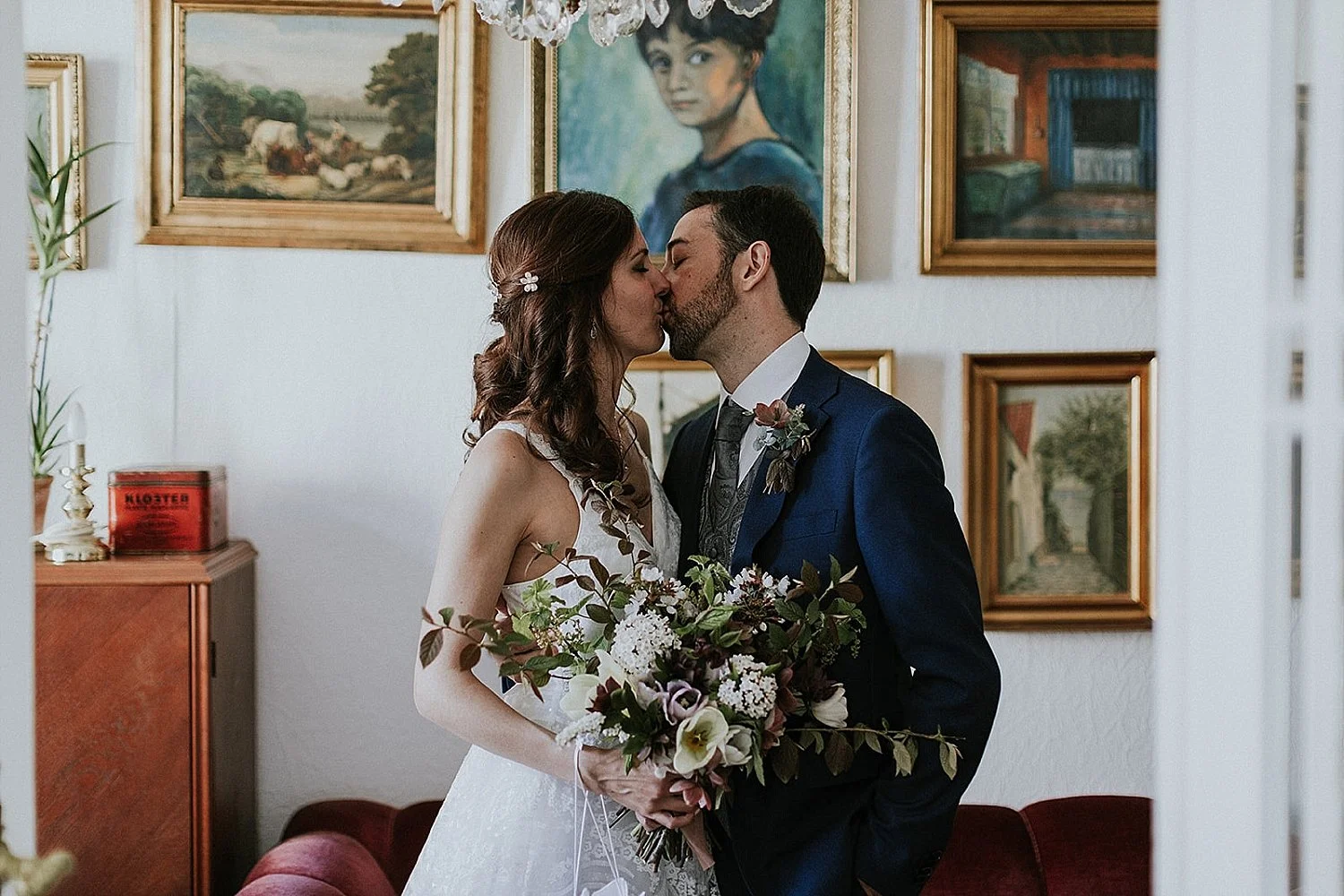 A newly married couple kissing and celebrating their premium wedding upgrades, featuring luxury champagne, bespoke bridal styling, and custom island flower decorations for an exclusive elopement in Denmark by Danish Island Weddings.