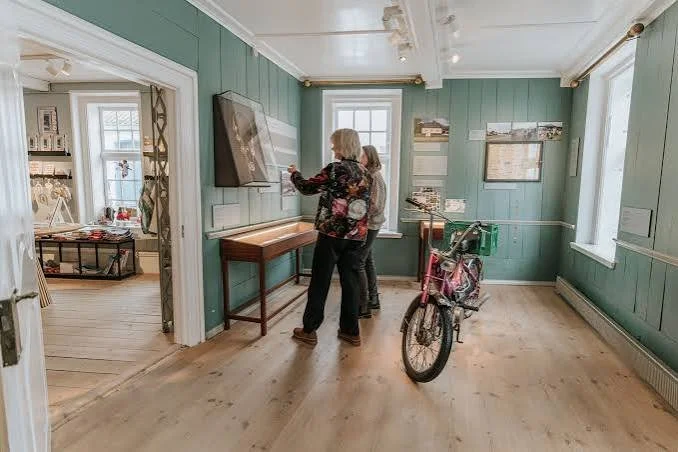 Visitors inside the historic rooms of Hammerichs Hus museum in Aeroeskoebing. An authentic cultural experience for couples visiting Aeroe Island for an elopement in Denmark.