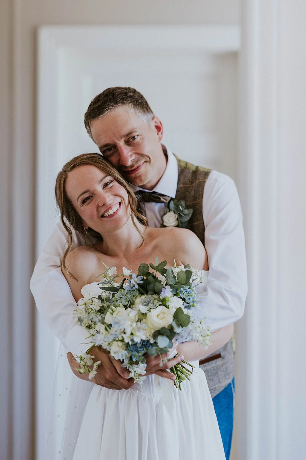 romantic-bride-and-groom-holding-bouquet.jpg