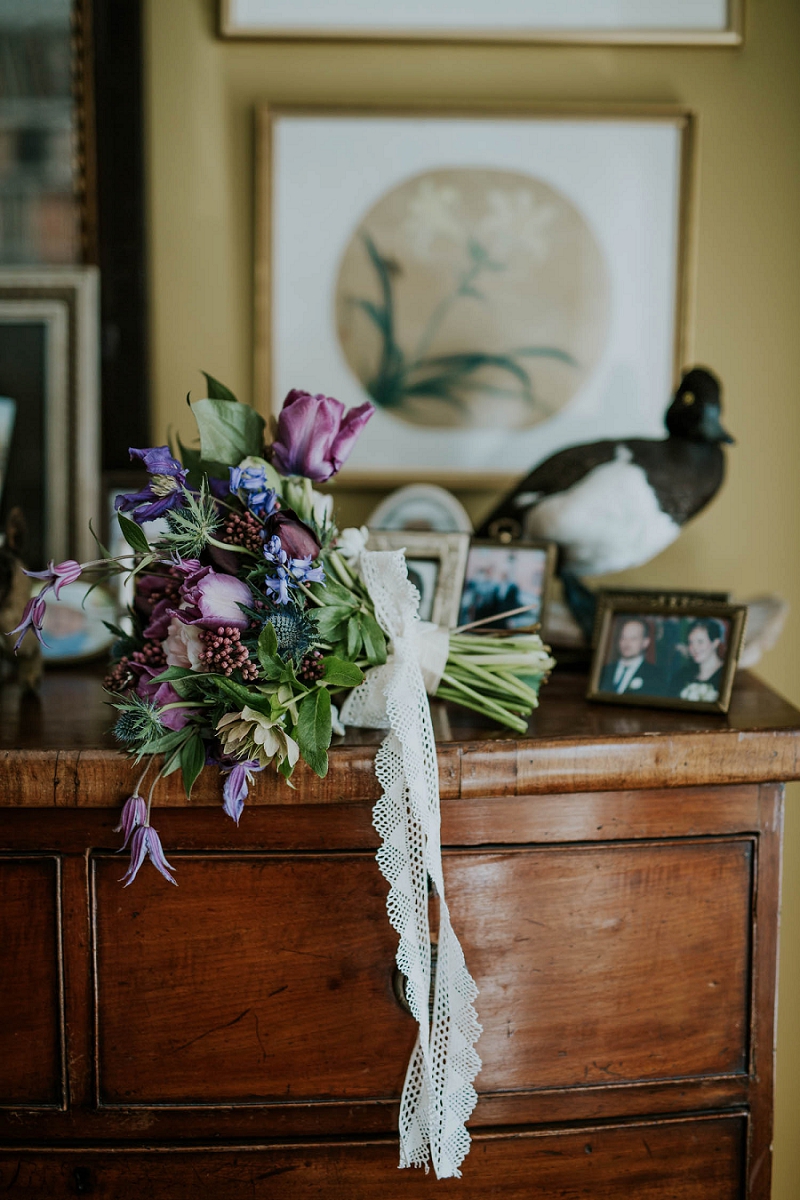 hand-tied wedding bouquet of pink purple blue flowers on vintage table | Denmark wedding planners and florist