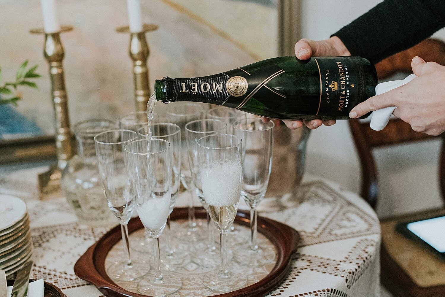 pouring champagne at intimate wedding reception in denmark