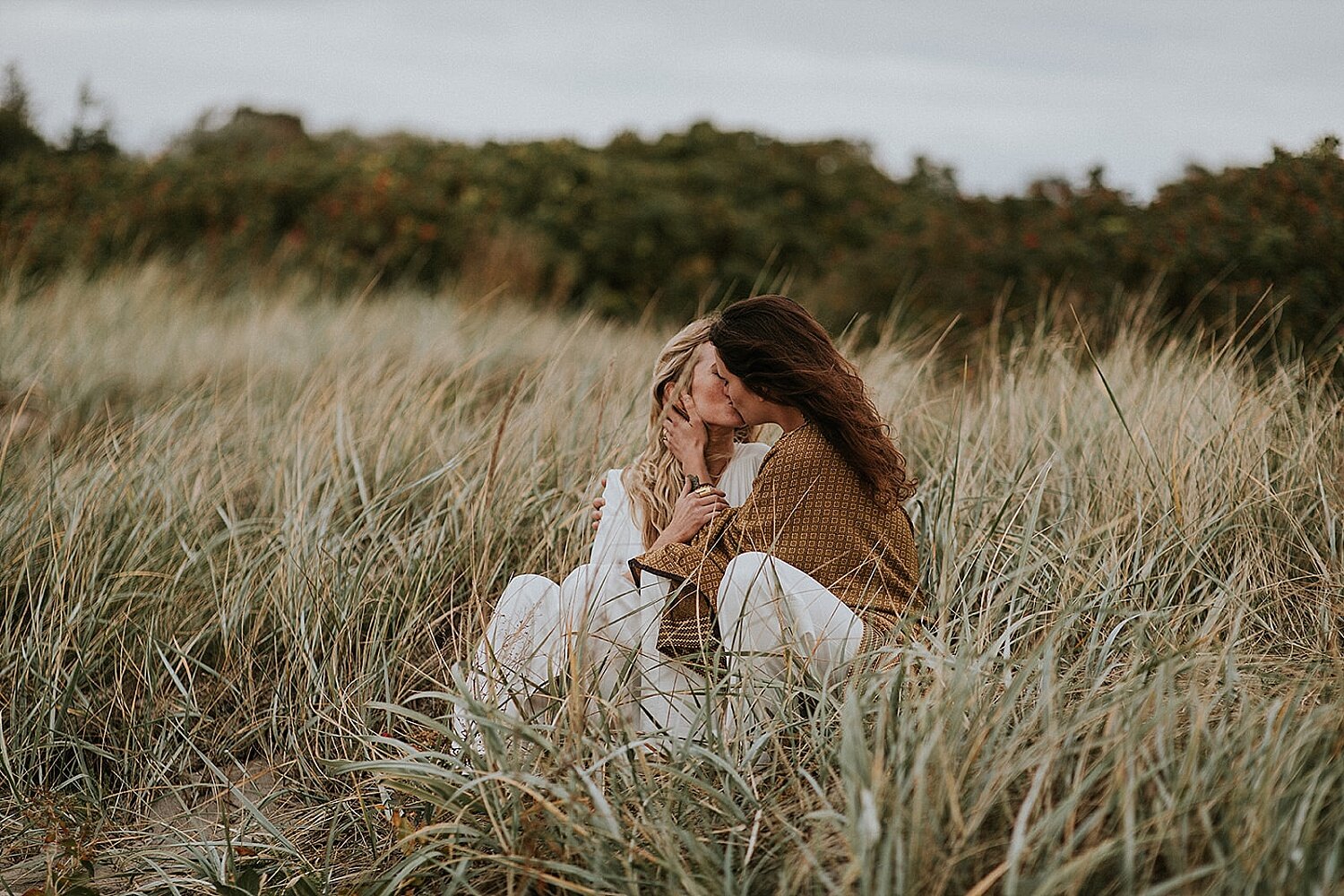 Two brides kissing on beach | Gay couple getting married in Denmark | lgbtq+ weddings | Denmark wedding venue | Aero Island | Danish Island Weddings | Full service wedding planners