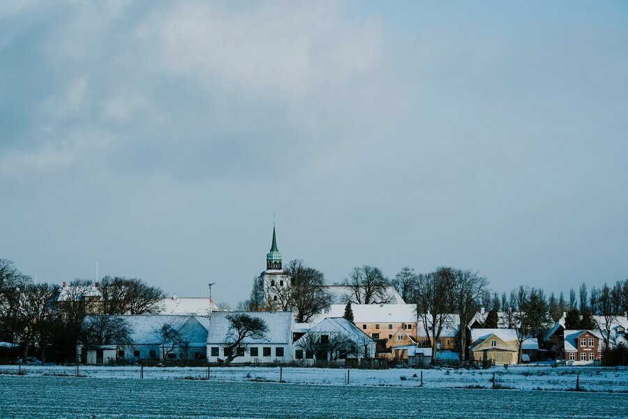 Snow-covered historic town of Aeroskobing with the church tower during winter season on Aeroe Island Denmark