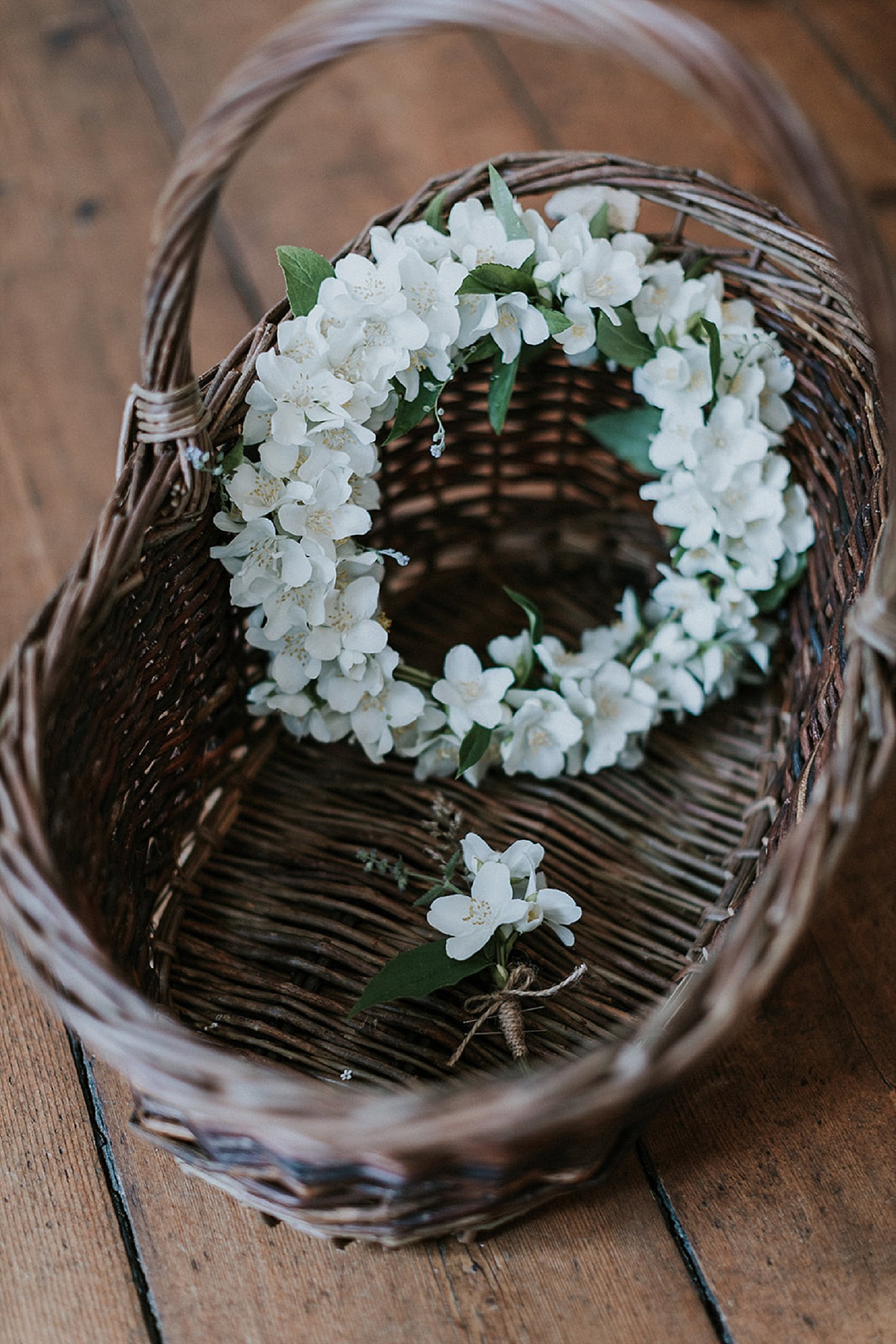 white floral crown in basket on wood floor | Denmark wedding planners and florist