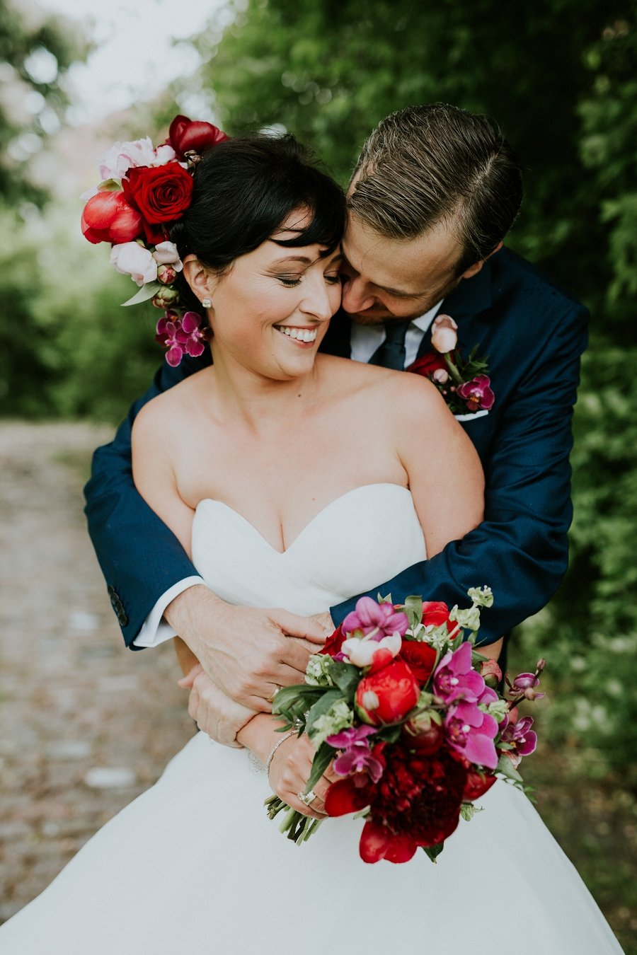 bride and groom with pink red wedding flowers  | Aero Island | Danish Island Weddings | Full service Denmark wedding planners