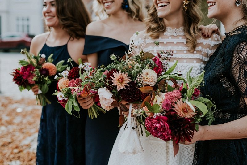 bridal party with bright late summer bloom floral bouquets fall wedding flowers woman with colorful floral crown | Aero Island | Danish Island Weddings | Full service Denmark wedding planners