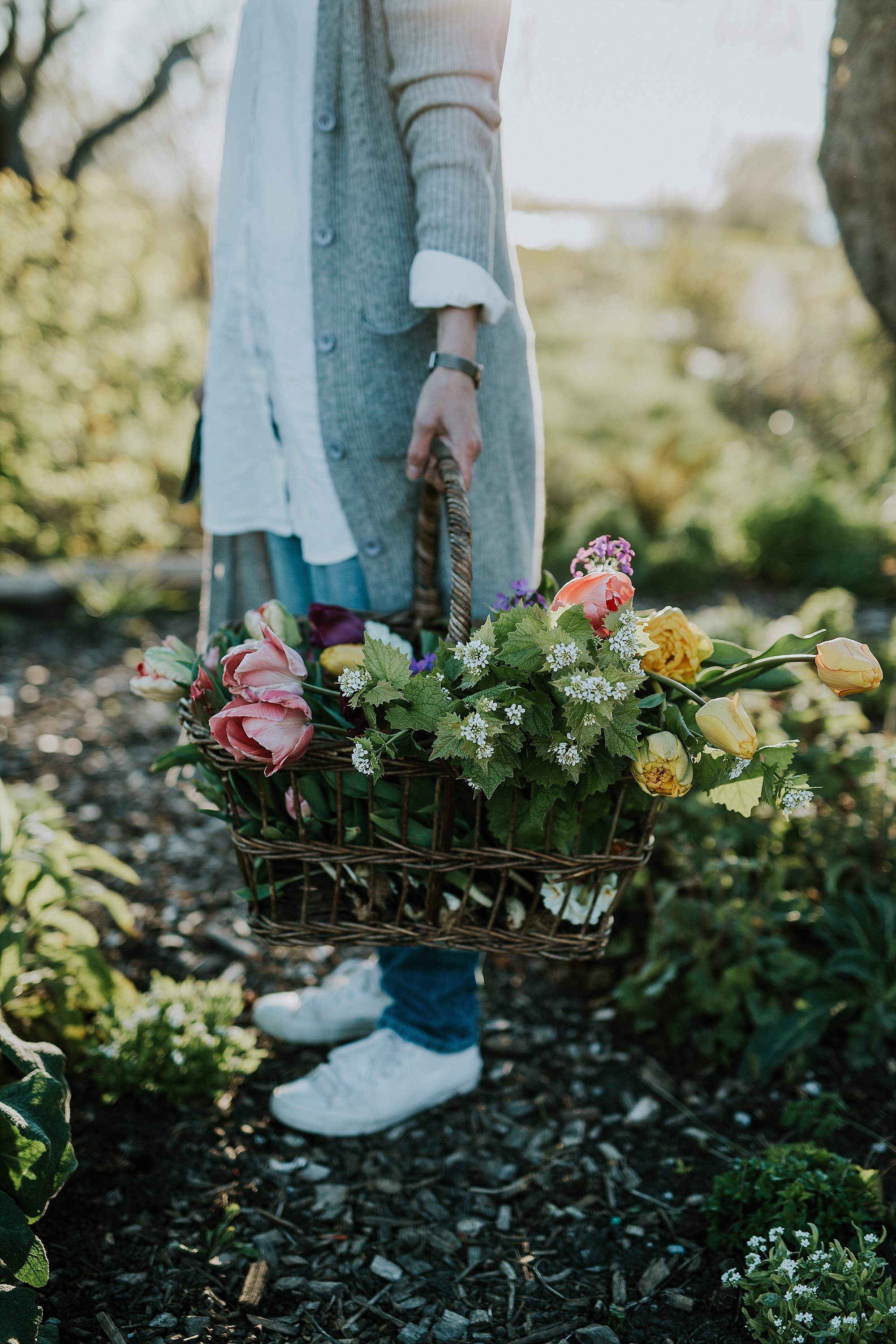 woman outside, holding fresh flowers in basket | Aero Island wedding planners | Denmark weddings and florists