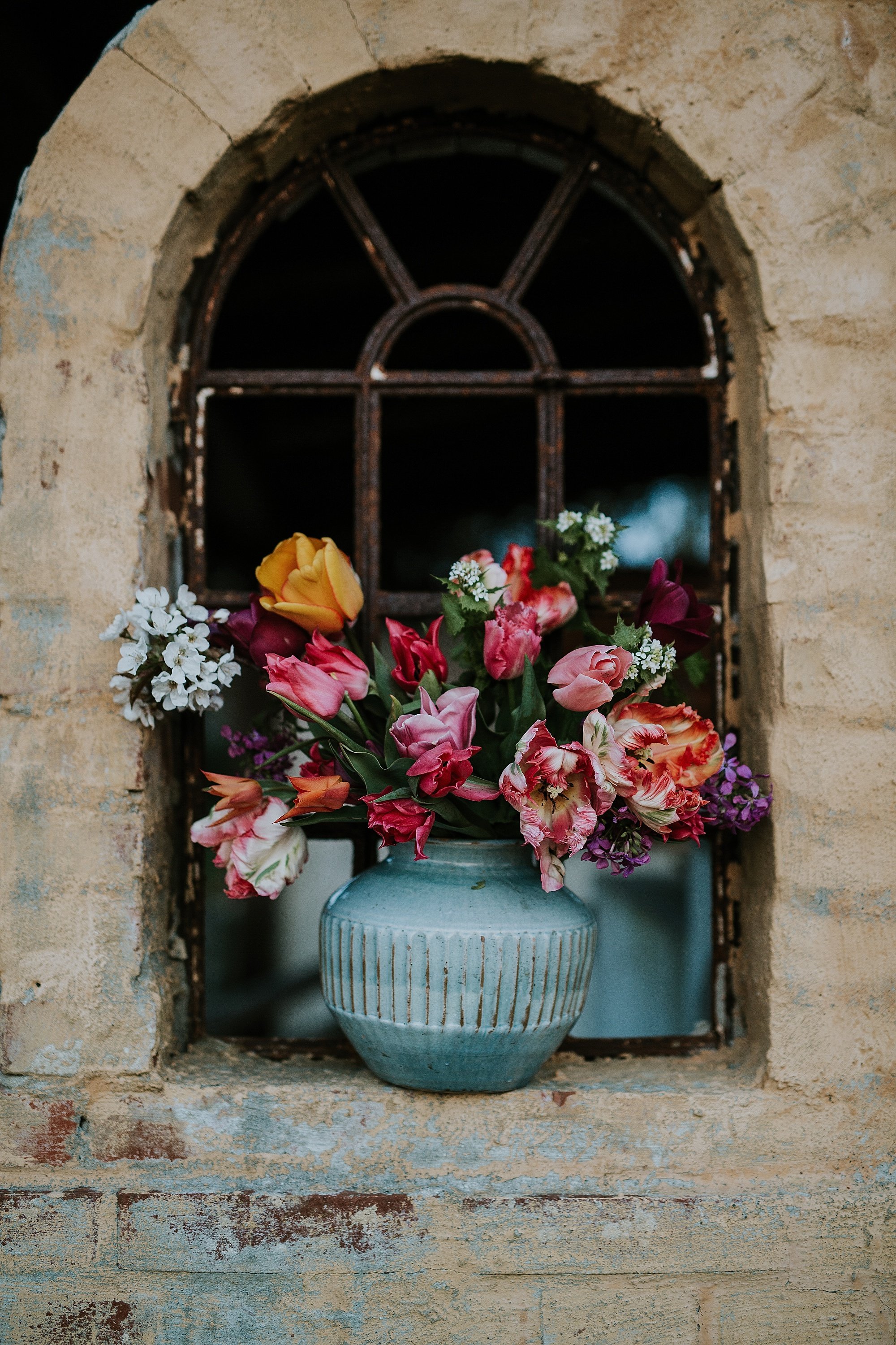 colorful long-stem flowers in vase on stone window ledge | Denmark wedding planners and florist