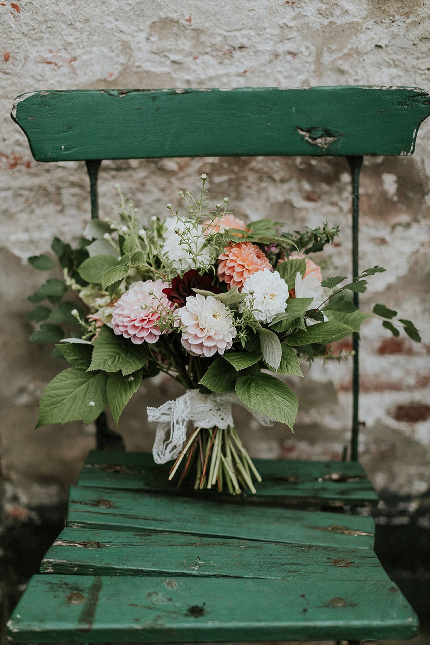 modern wedding bouquet modern floral arrangement on green wooden chair | Get married abroad | Aero Island | Danish Island Weddings | Full service Denmark wedding planners 