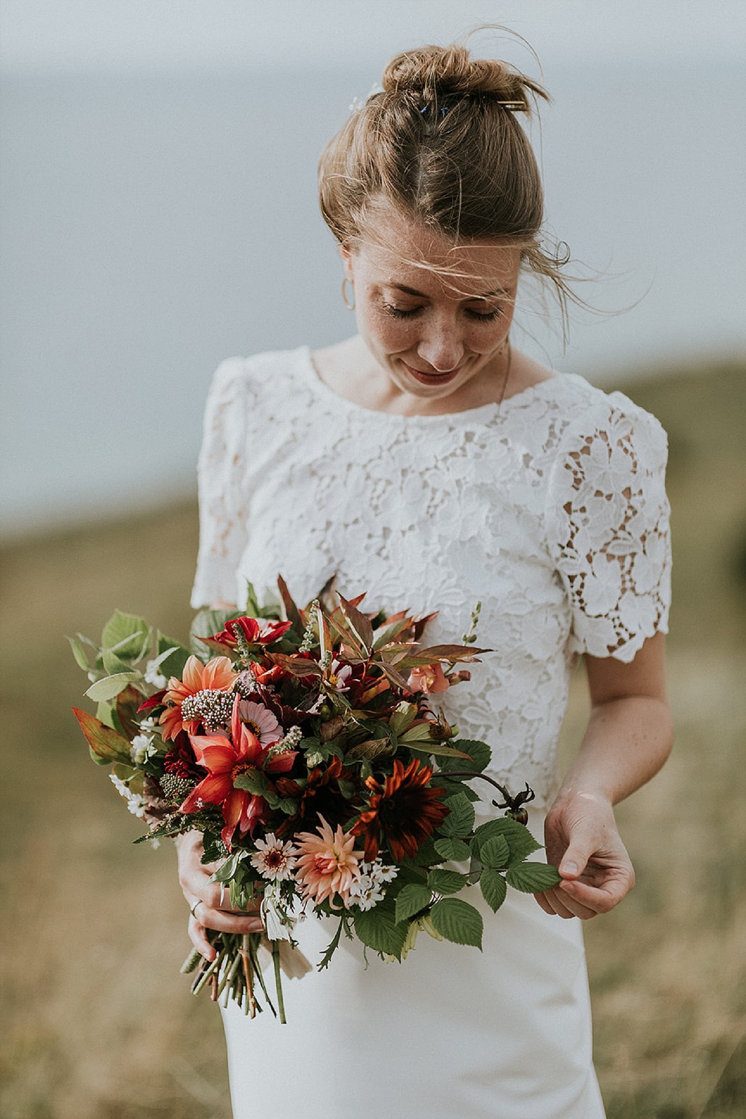 bride on beach holding fall wedding bouquet | elope abroad | Aero Island | Danish Island Weddings | Full service Denmark wedding planners 