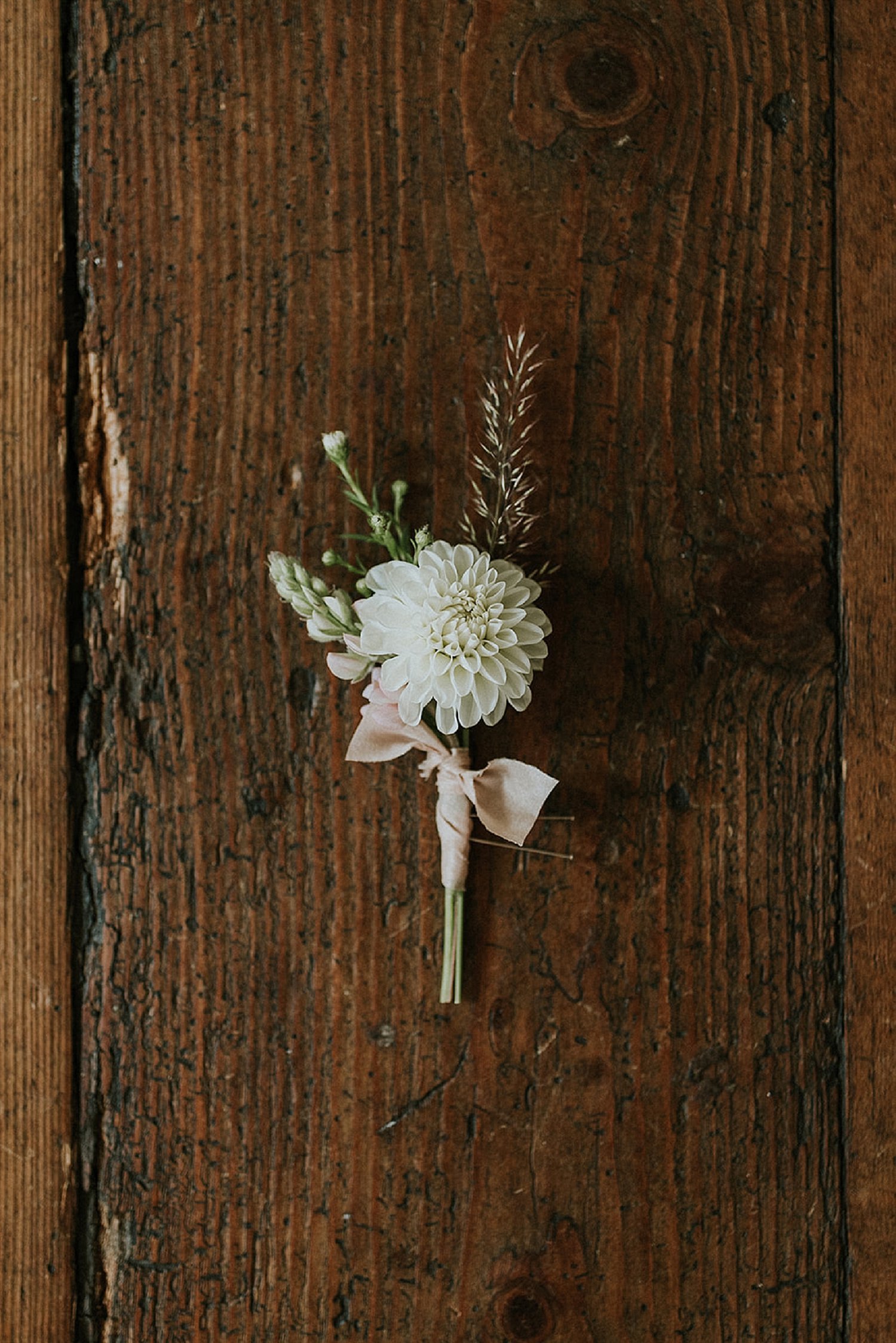 Groom's boutonniere on weathered wood