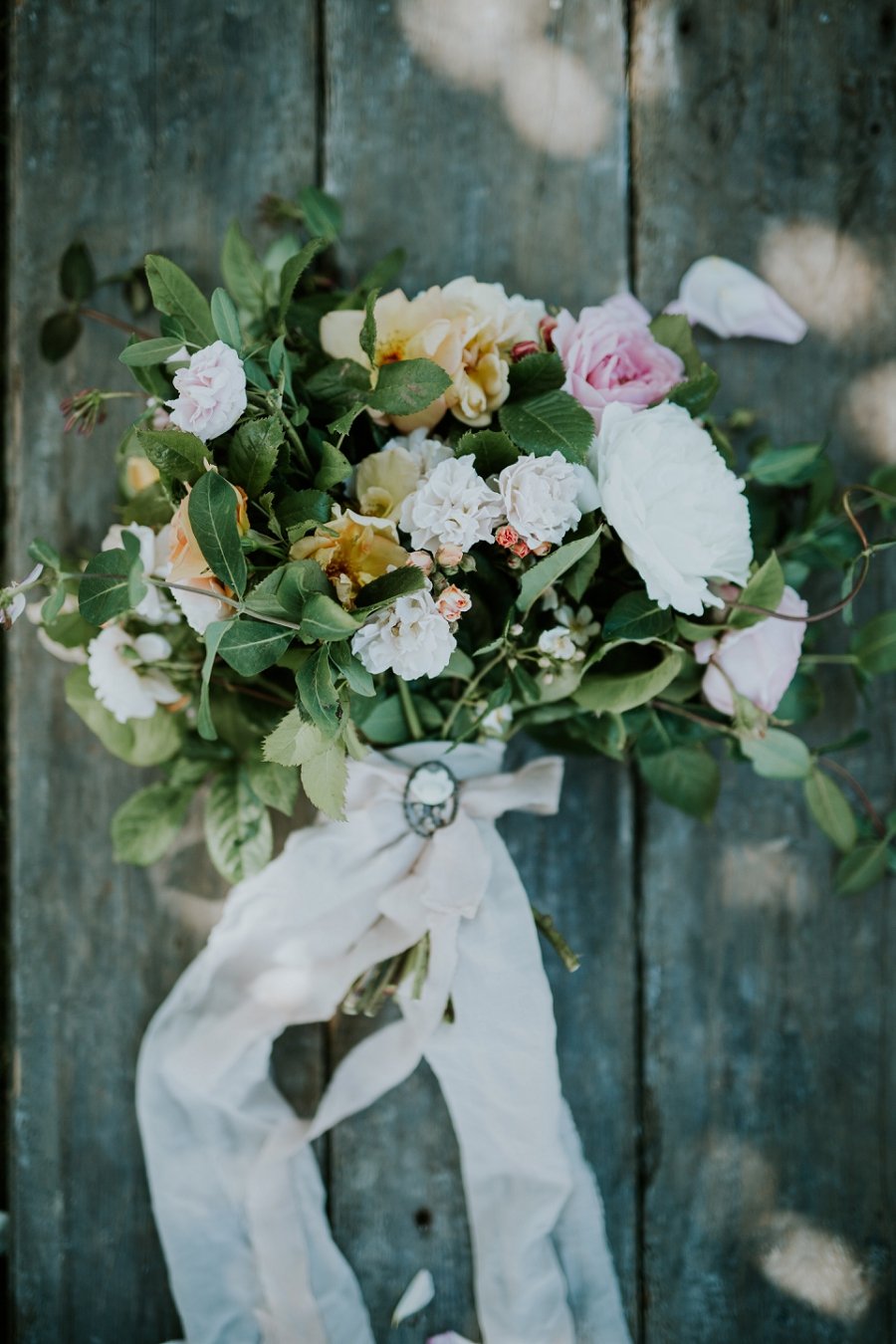 bouquet of flowers with ribbon on woodbouquet of flowers with ribbon on vintage chair | Danish Island Weddings | Full service Denmark wedding planners