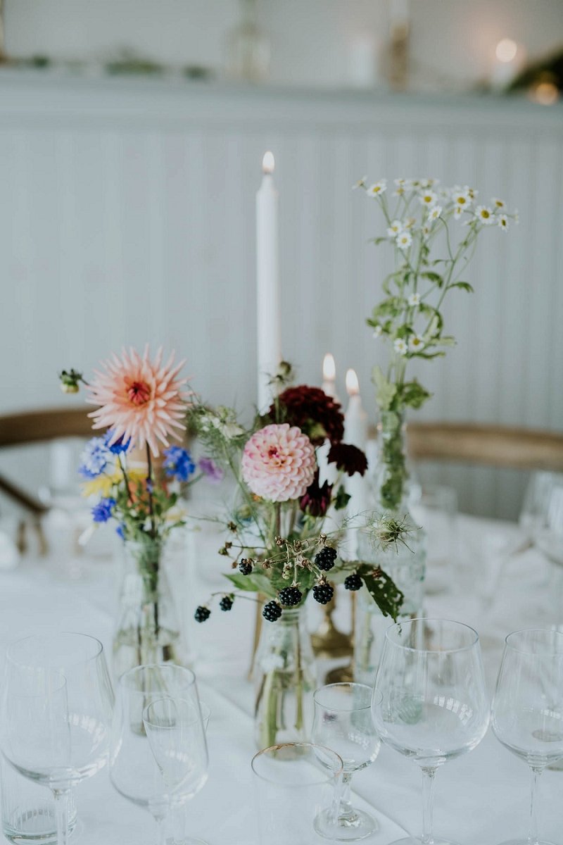 pink peach white floral stems in glass vases on table | Danish Island Weddings | Full service Denmark wedding planners