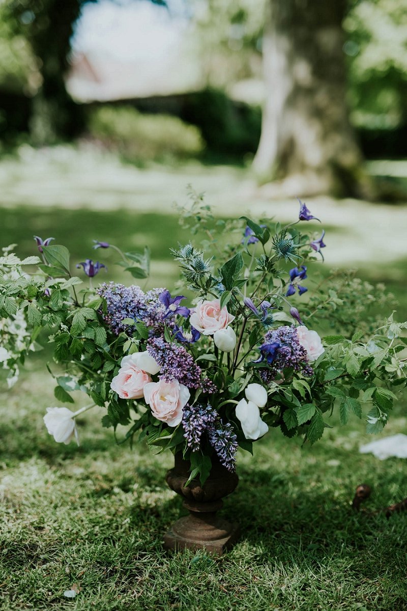 pink blue green flowers in vase on grass | Get married abroad | Danish Island Weddings | Full service Denmark wedding planners