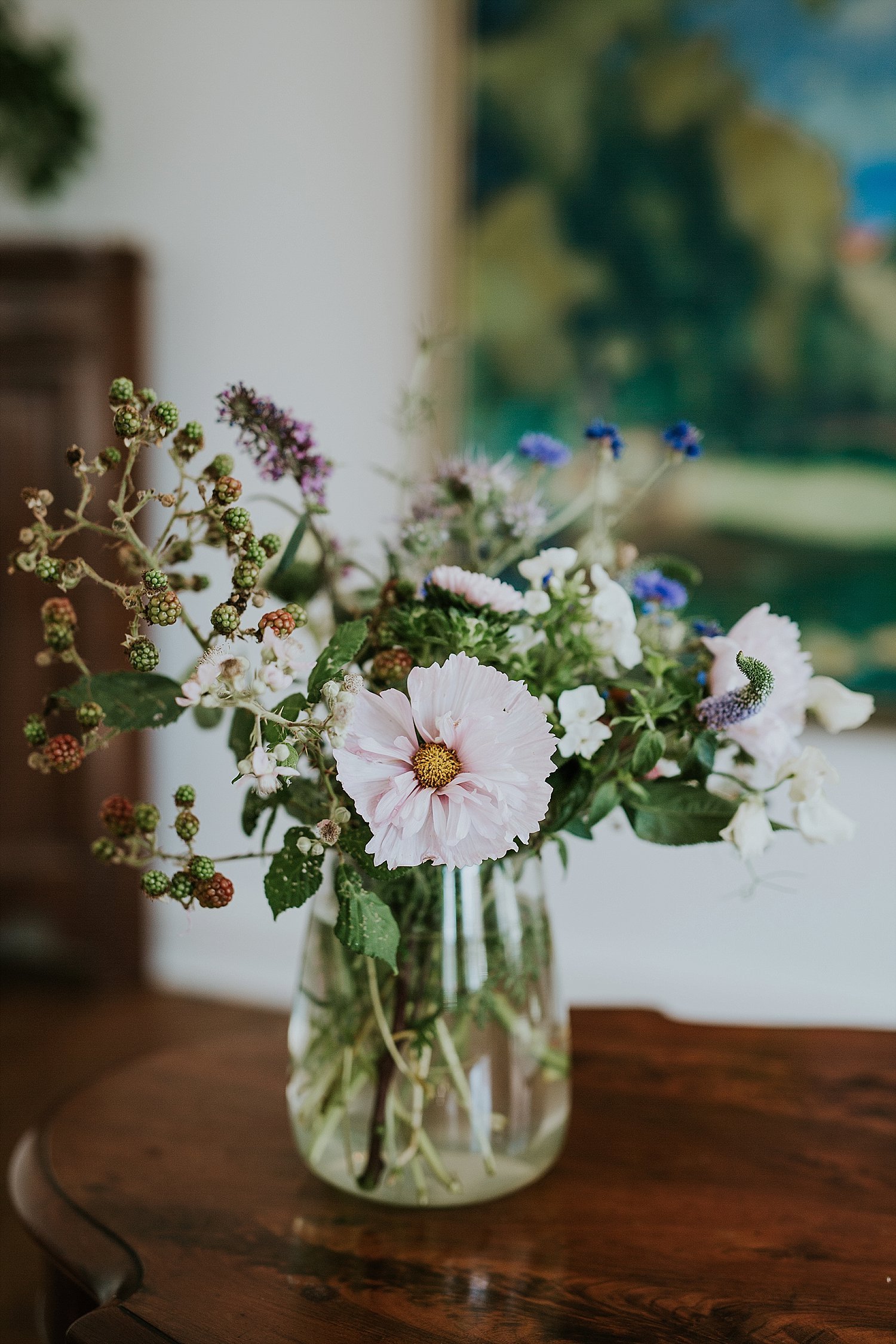 small floral centerpiece in glass jar on table | elope abroad | Aero Island | Danish Island Weddings | Full service Denmark wedding planners 