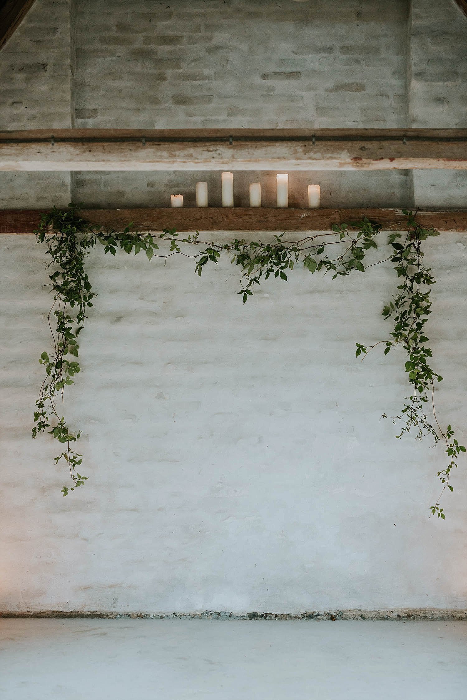 simple wedding backdrop with greenery swag and candles  | get married in Europe | Aero Island | Danish Island Weddings | Full service Denmark wedding planners 