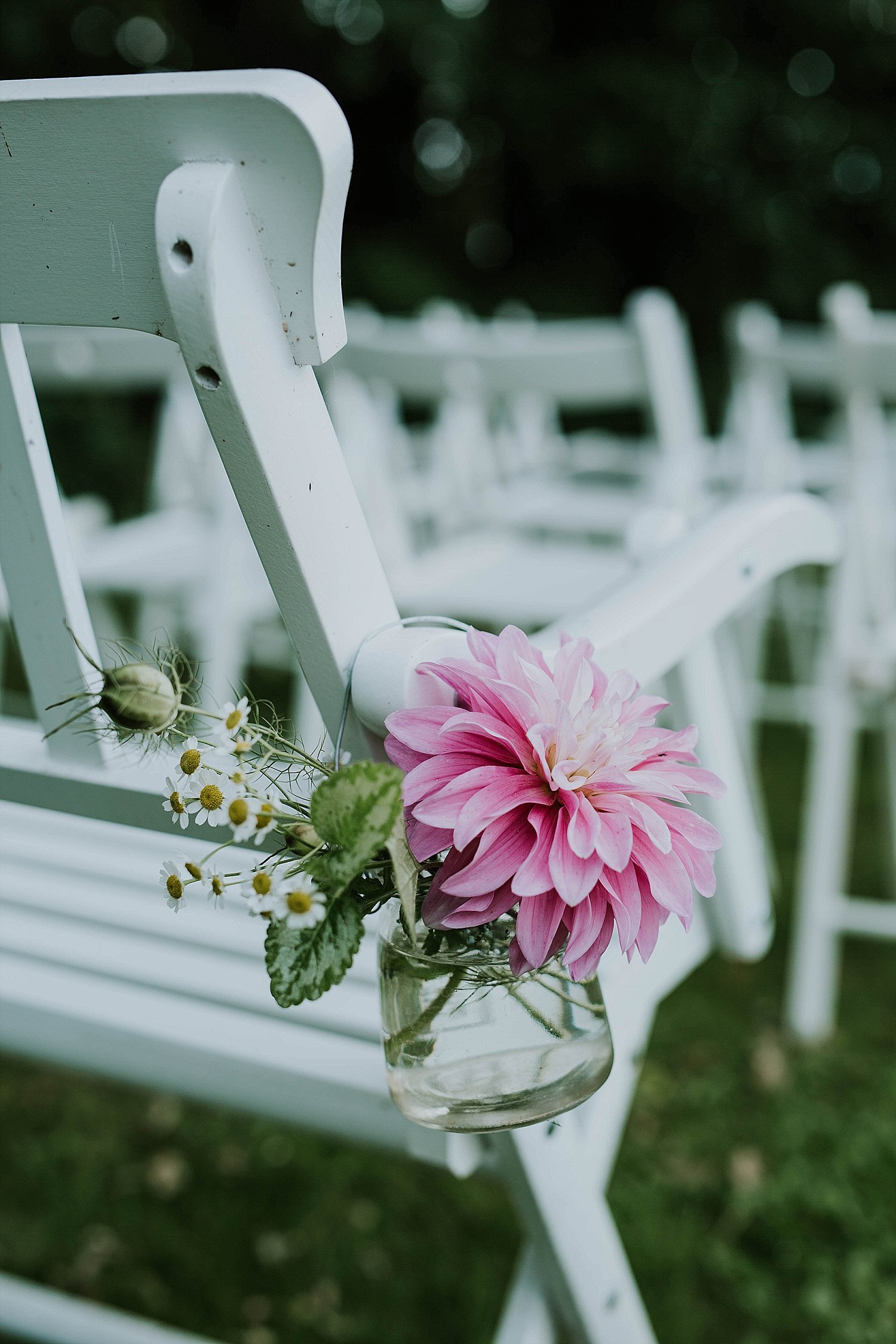 small floral arrangement tied to chair bench minimalist wedding decor aisle marker | Aero Island | Danish Island Weddings | Full service Denmark wedding planners