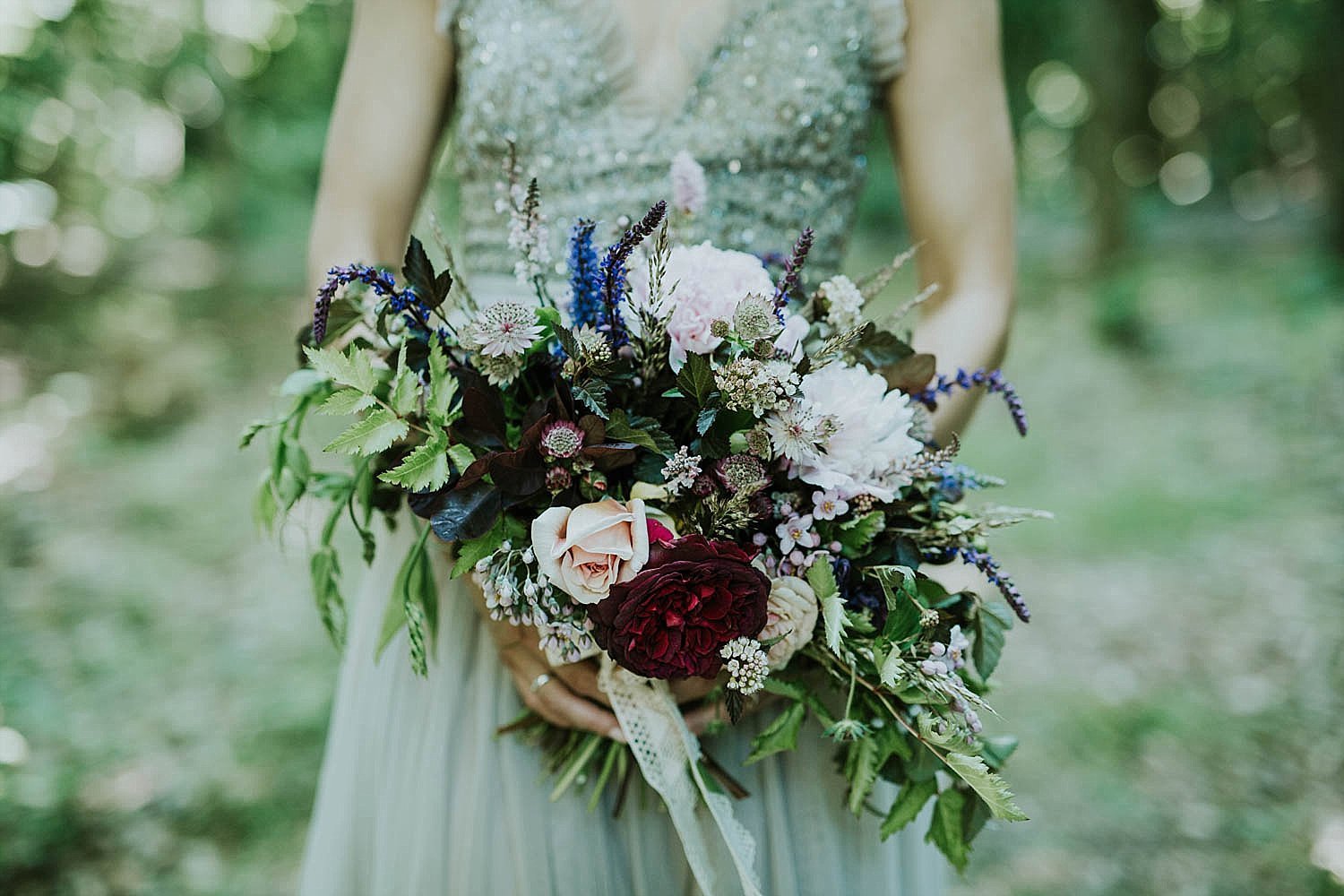 bride holding asymmetrical modern wedding bouquet outdoor wedding  | Aero Island | Danish Island Weddings | Full service Denmark wedding planners