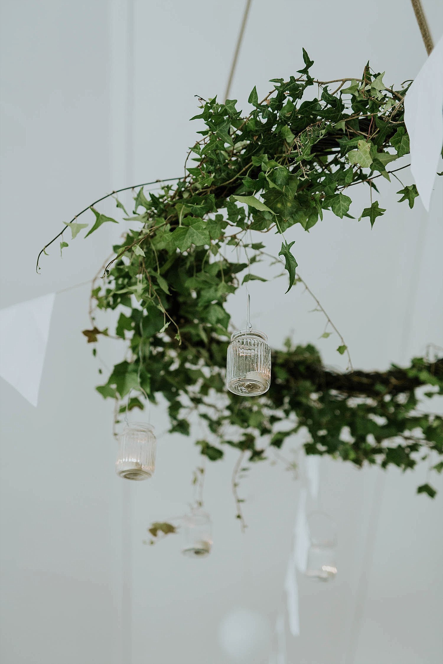 greenery and candles on hanging hoop | modern garden wedding | minimalist wedding decor  | Aero Island | Danish Island Weddings | Full service Denmark wedding planners
