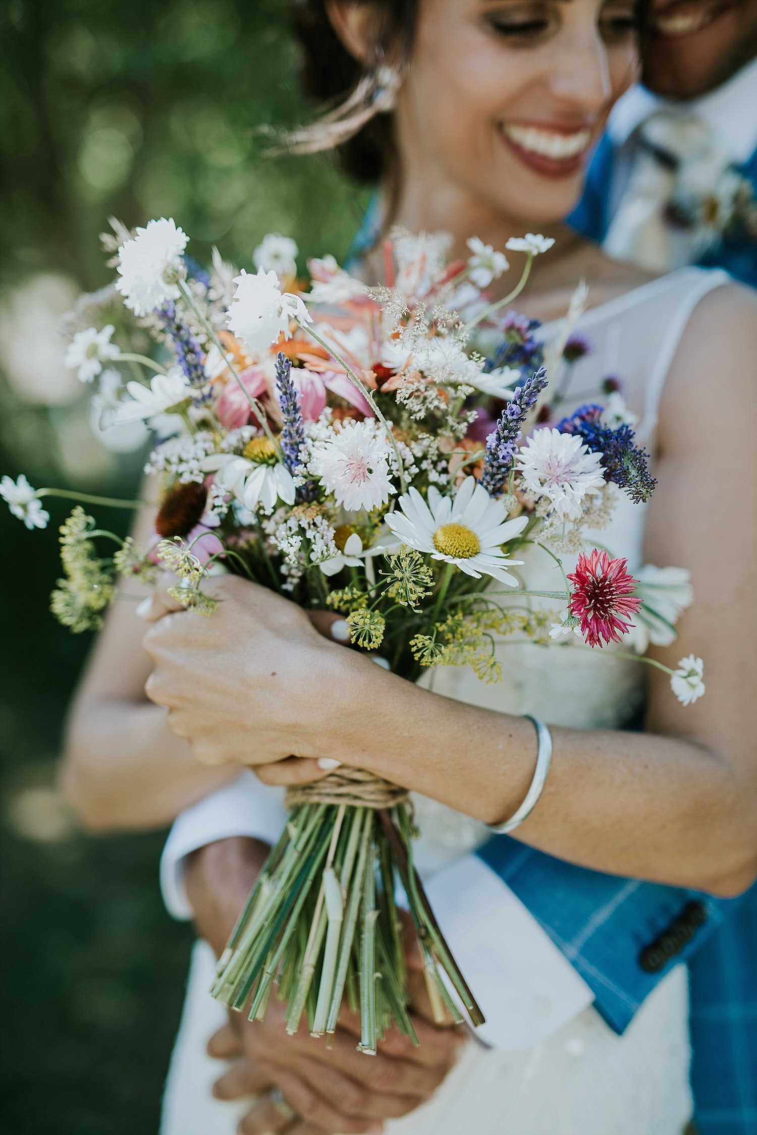 Bride and groom in embrace with flowers