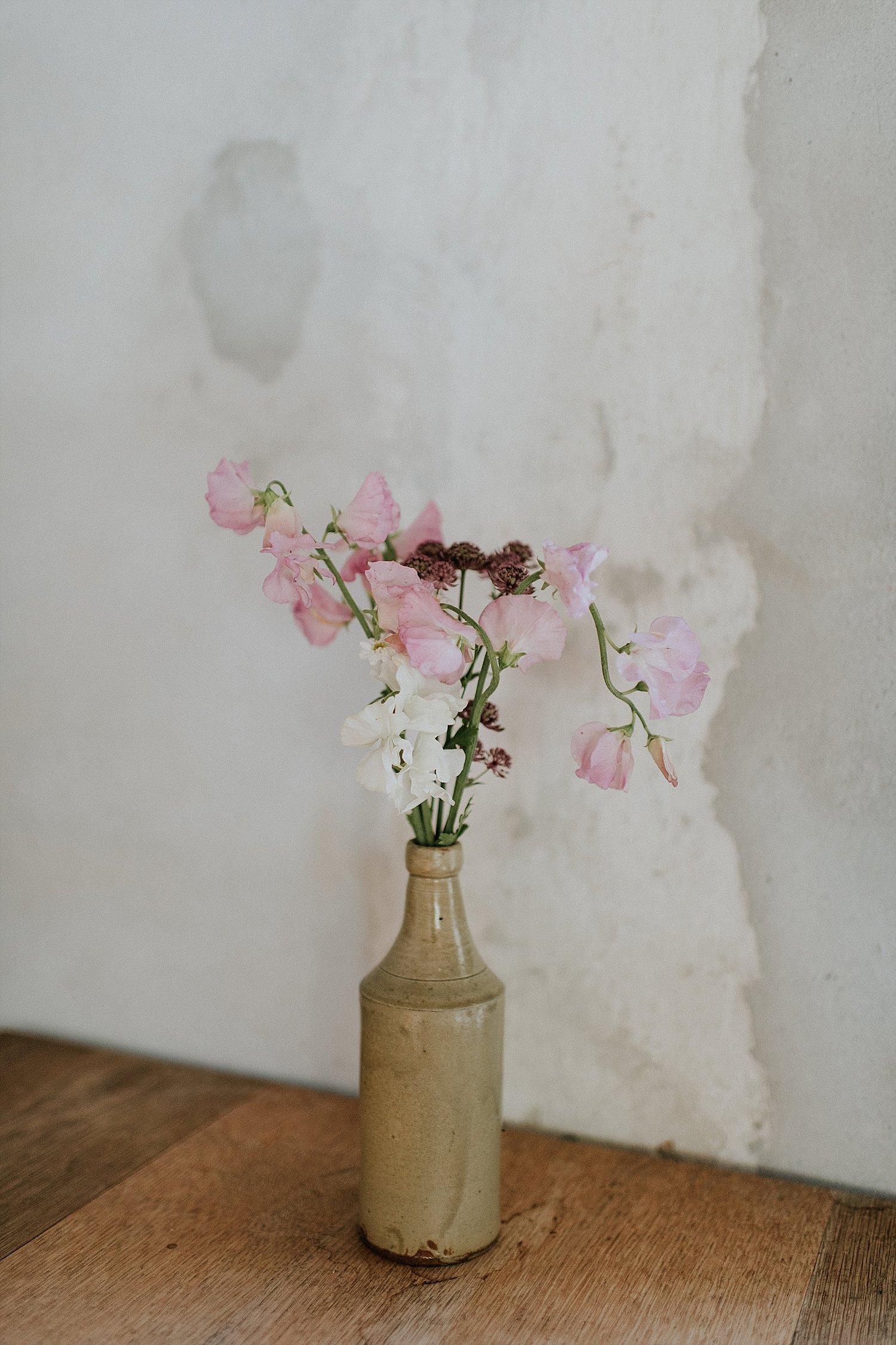 small arrangement of pink and white flowers in vase