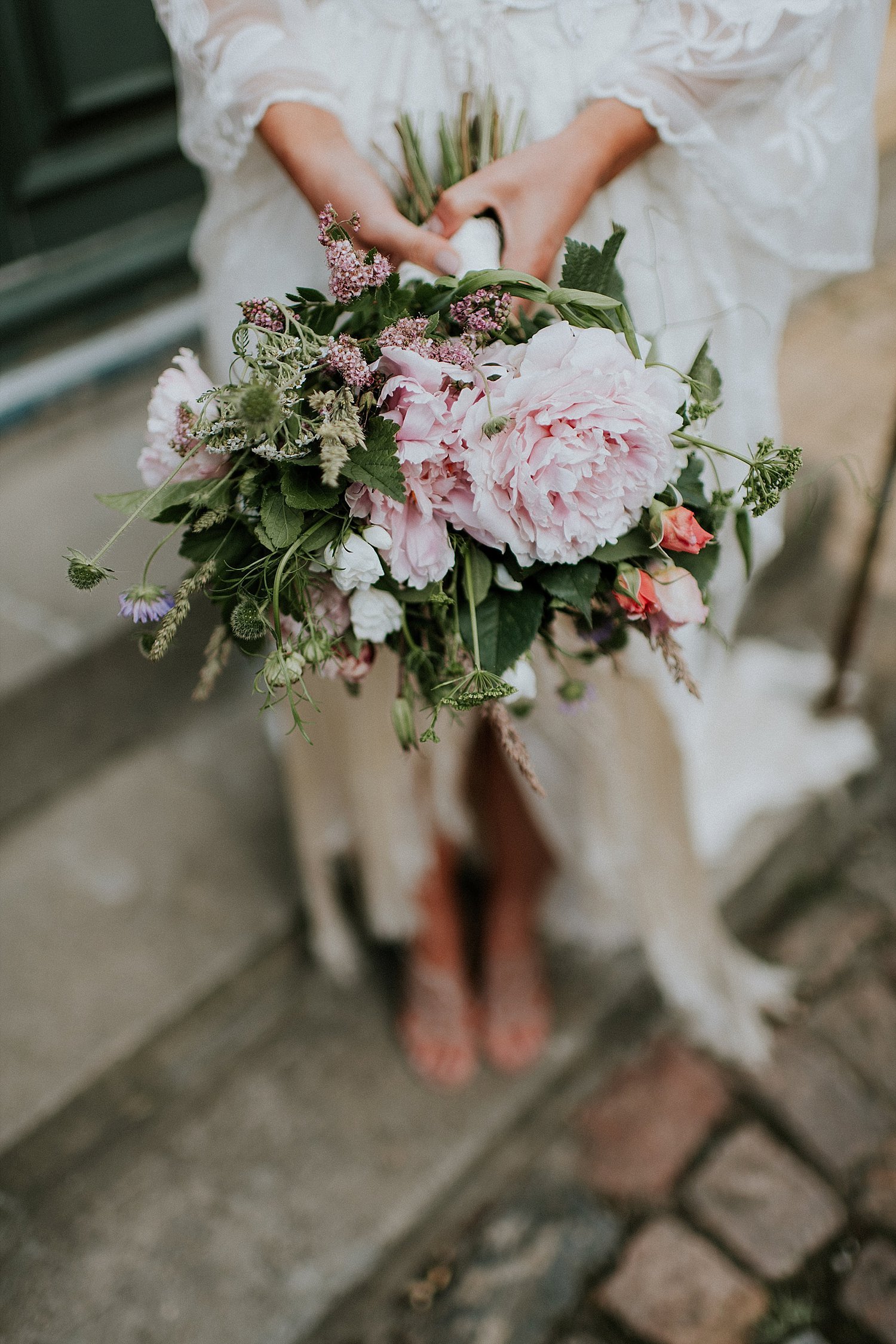 woman holding wedding bouquet with pink peony | Aero Island | Danish Island Weddings | Full service Denmark wedding planners