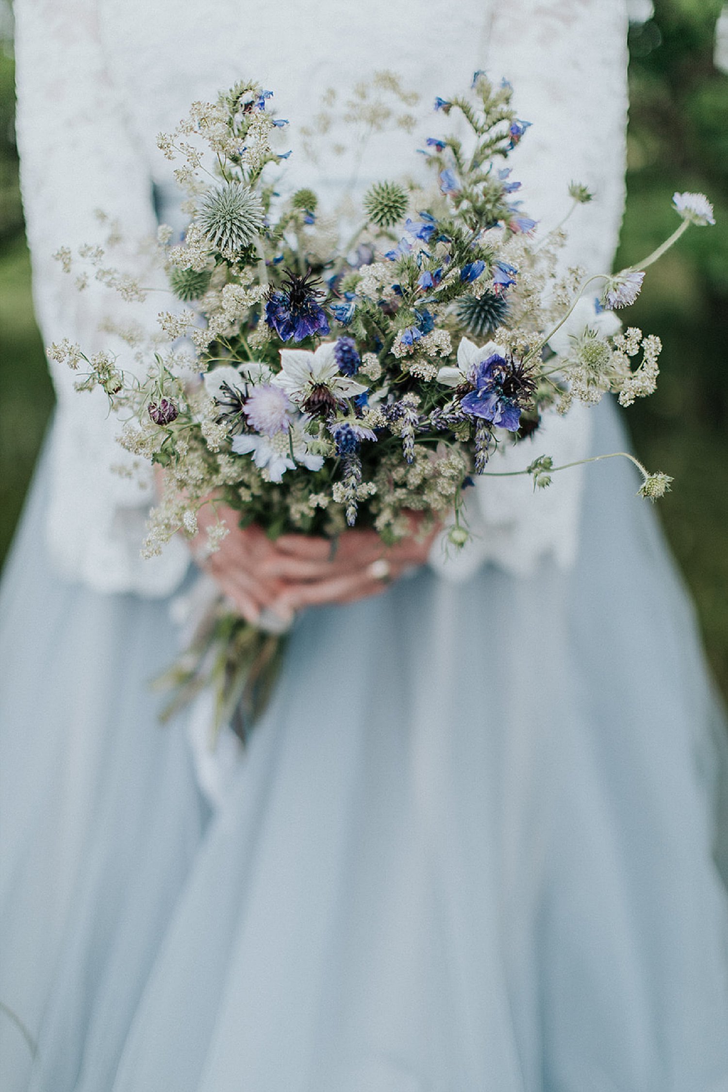 Bride holding bouquet of blue and white flowers