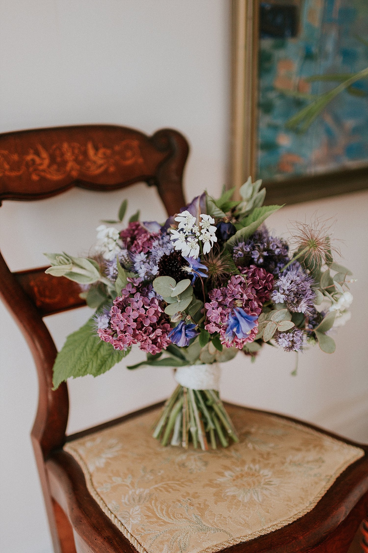 wedding bouquet of pink purple blue white flowers on vintage chair | Aero Island wedding planners | Denmark weddings and florists