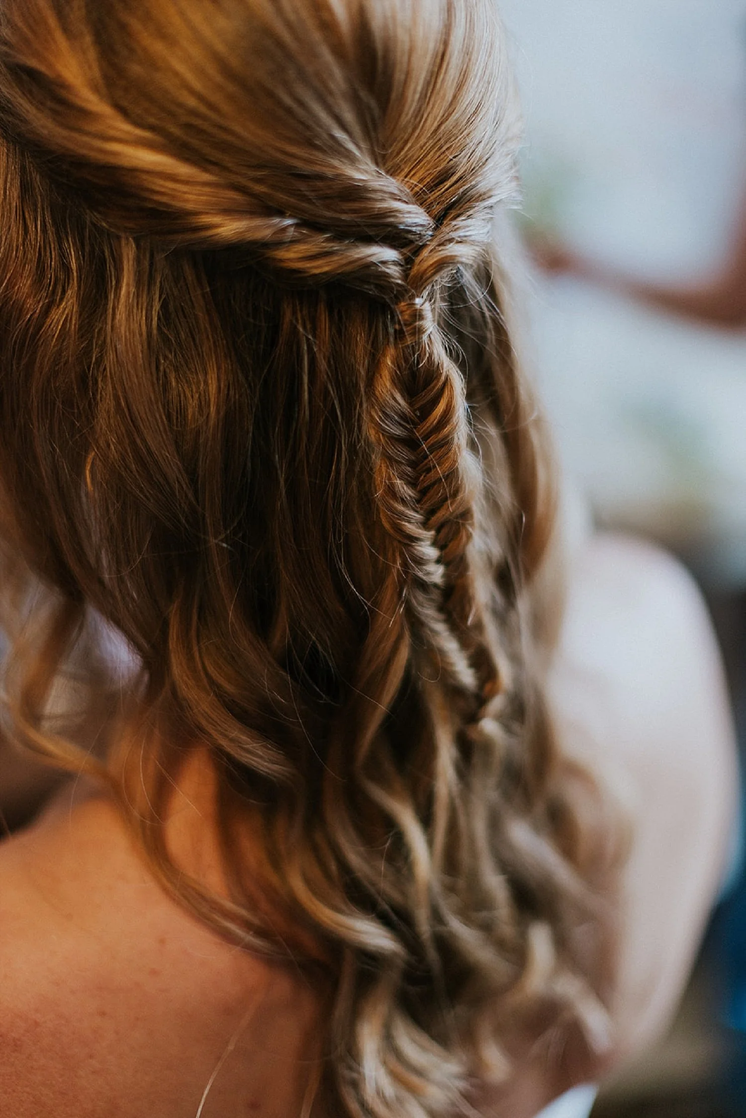 Closeup of wedding hair styling detail on a medium blonde bride from behind