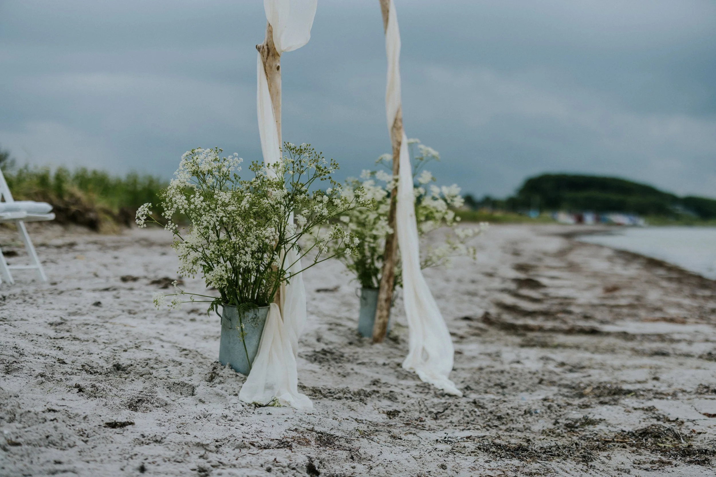 beach-wedding-arch-silk-zinc-buckets-flowers.jpg
