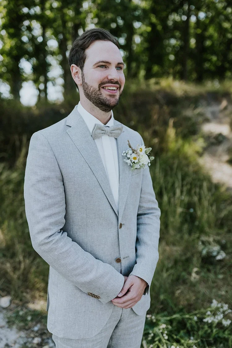 full-length-groom-portrait-light-grey-suit-pastel-boutonniere